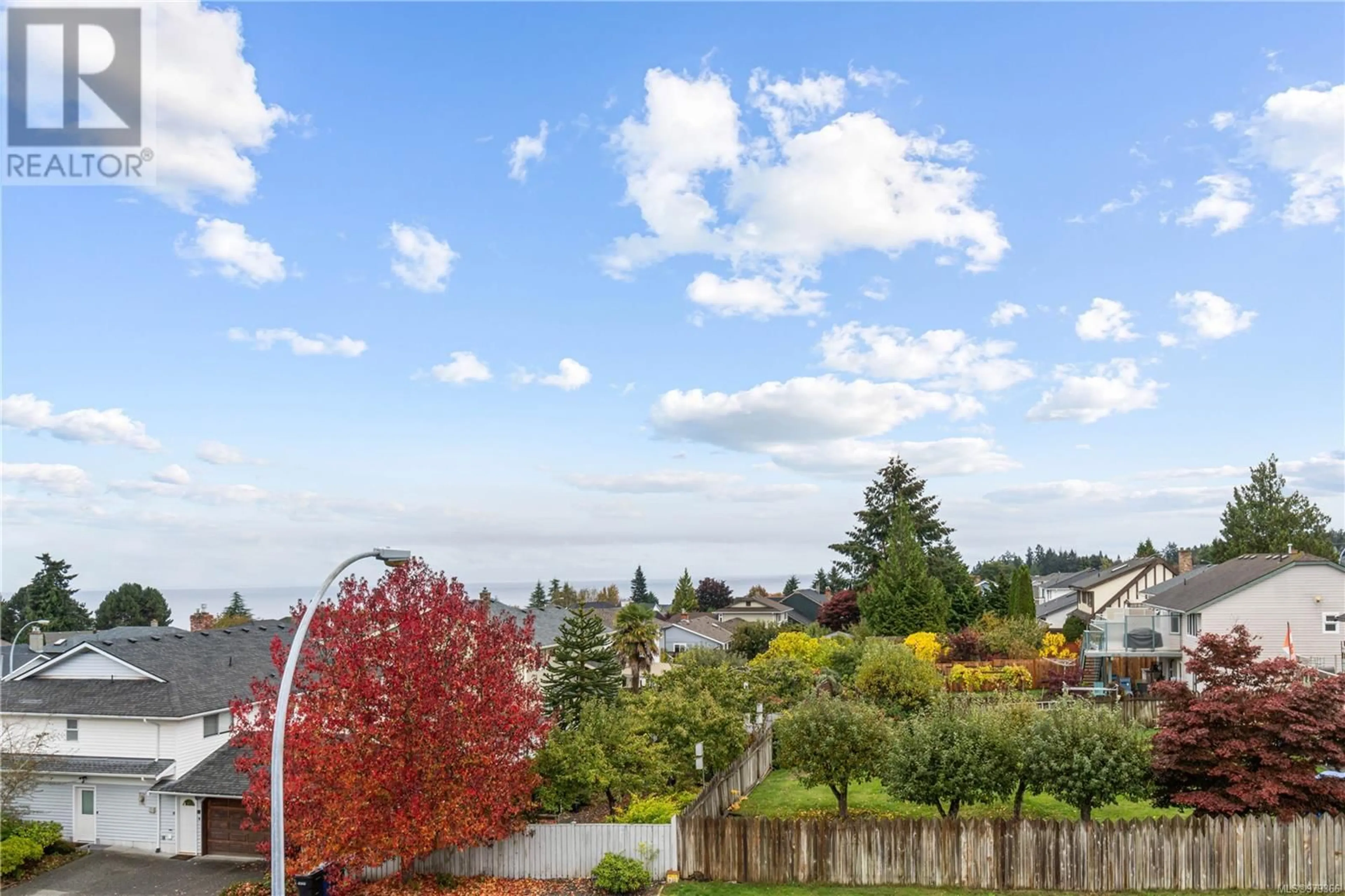 A pic from exterior of the house or condo, the fenced backyard for 216A 6231 Blueback Rd, Nanaimo British Columbia V9V1J3