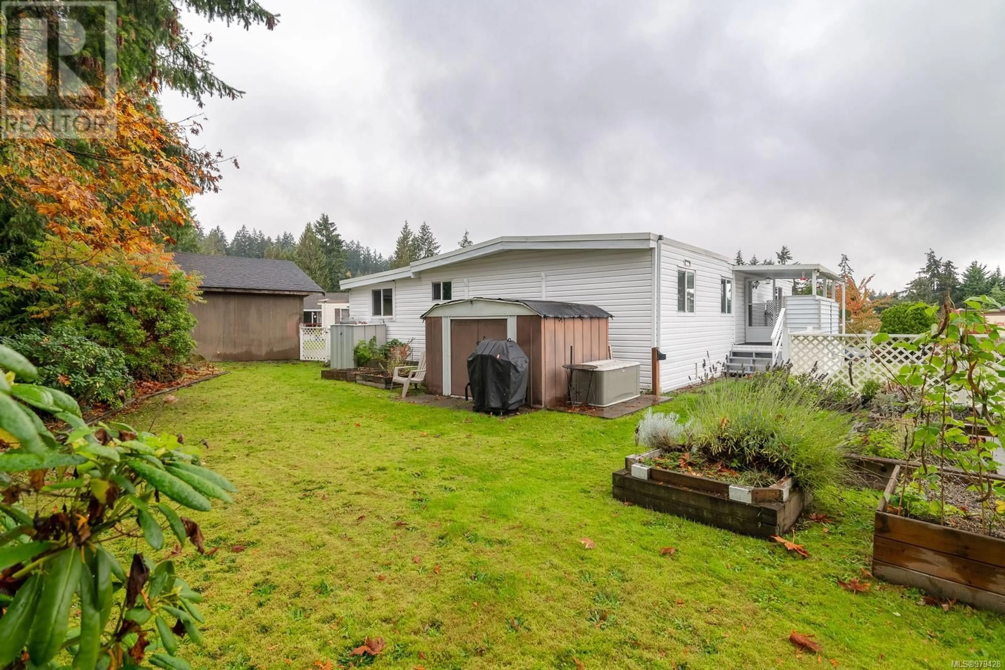 Frontside or backside of a home, the fenced backyard for 40 61 Twelfth St, Nanaimo British Columbia V9R6L3