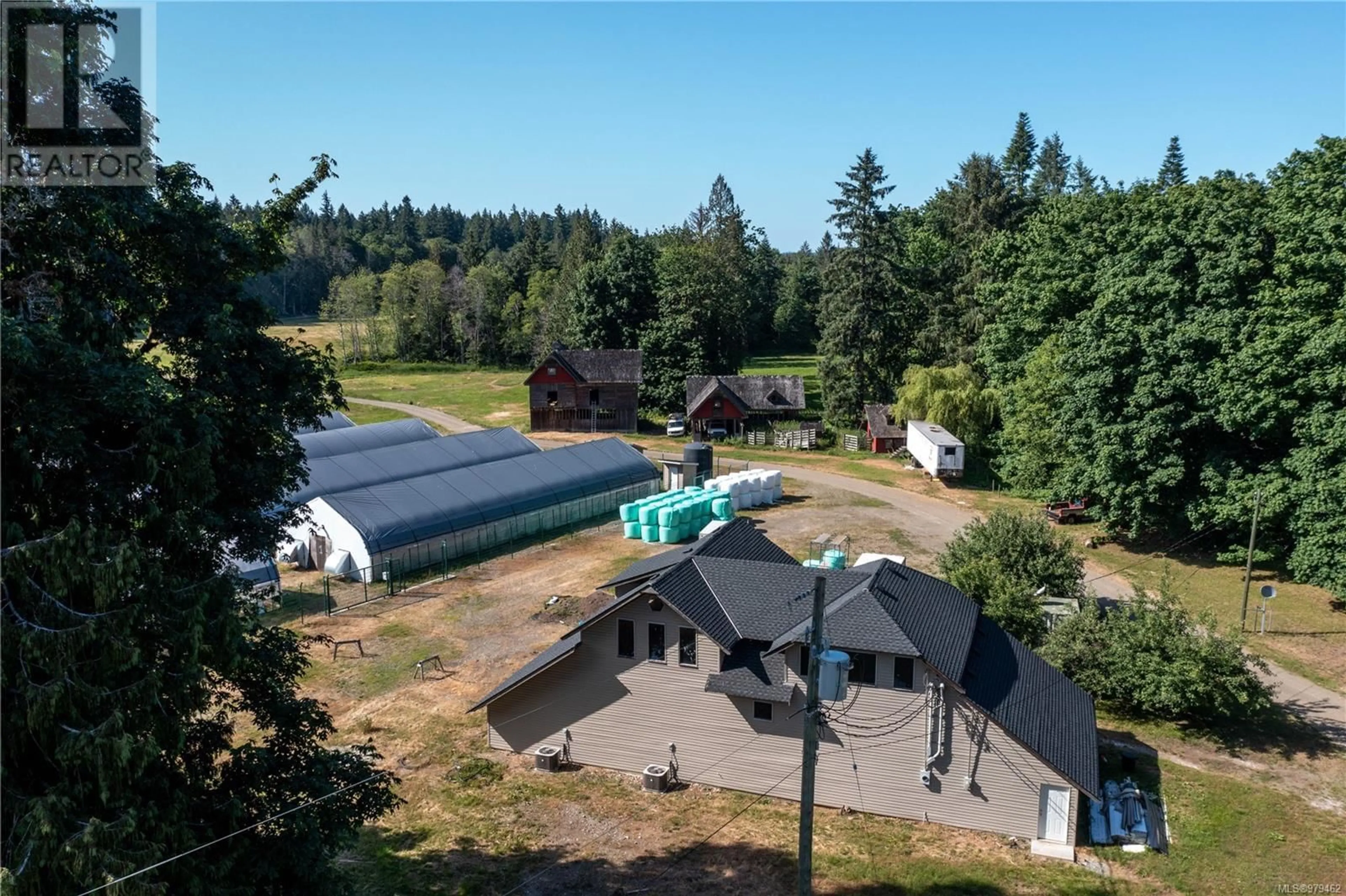 Frontside or backside of a home, the fenced backyard for 8991 Island Hwy S, Fanny Bay British Columbia V0R1W0