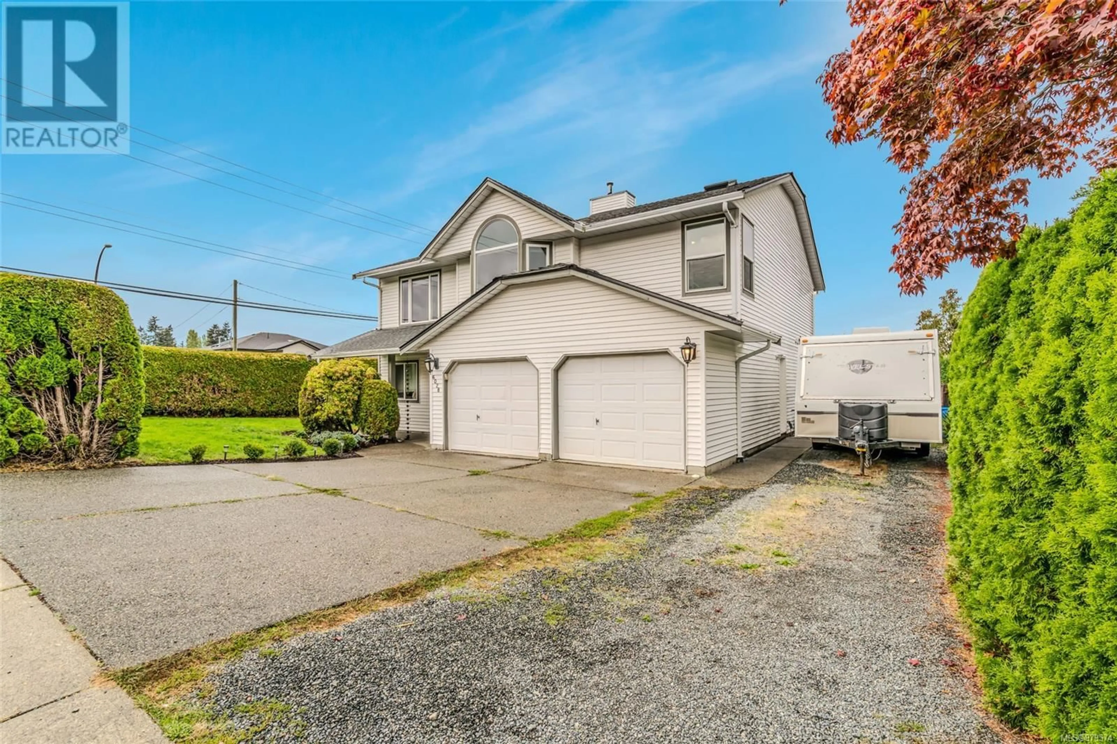 Frontside or backside of a home, the fenced backyard for 6028 Newport Dr, Nanaimo British Columbia V9V1M6