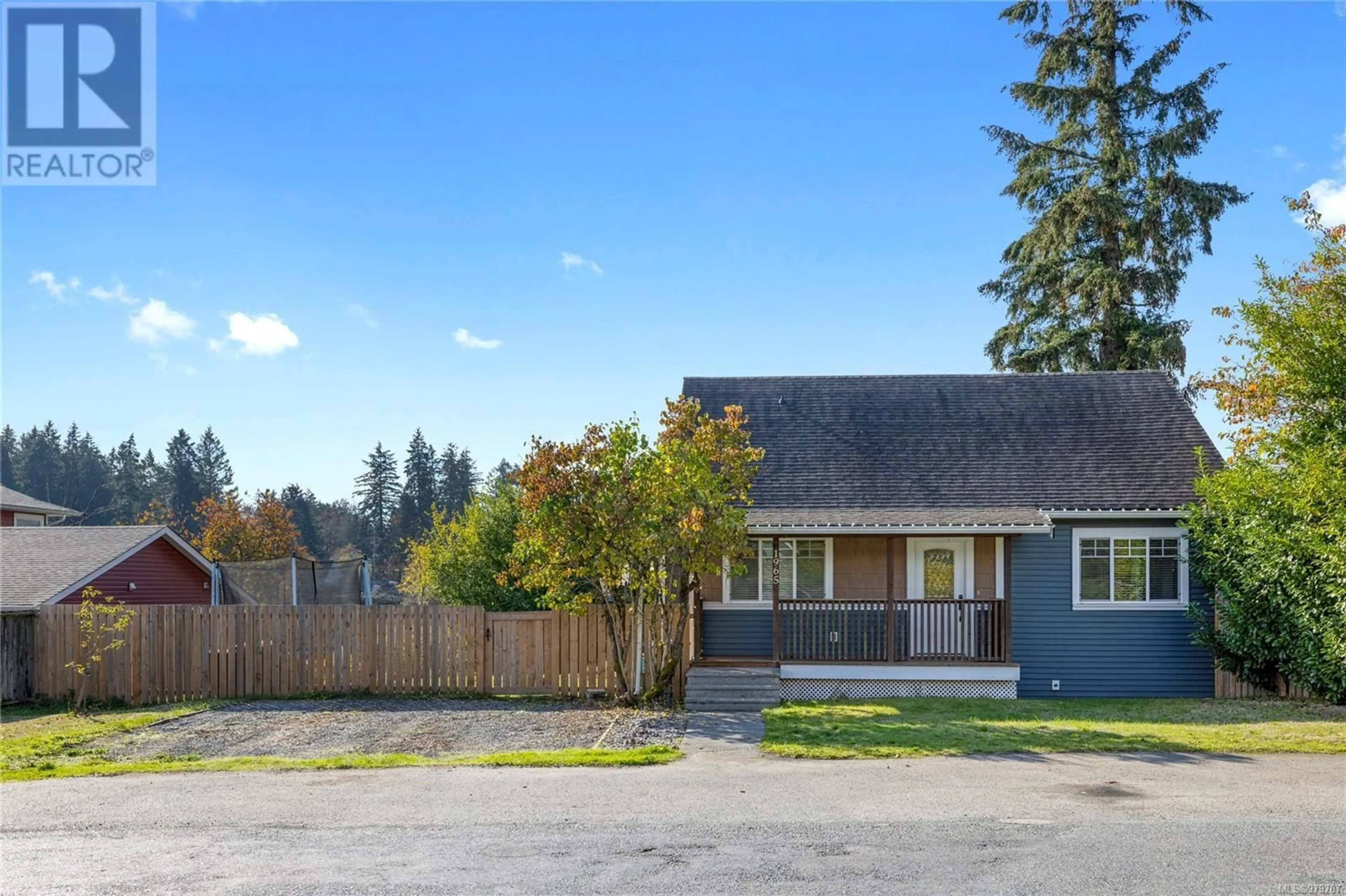 Frontside or backside of a home, the fenced backyard for 1965 Walsh Rd, Nanaimo British Columbia V9X1M1