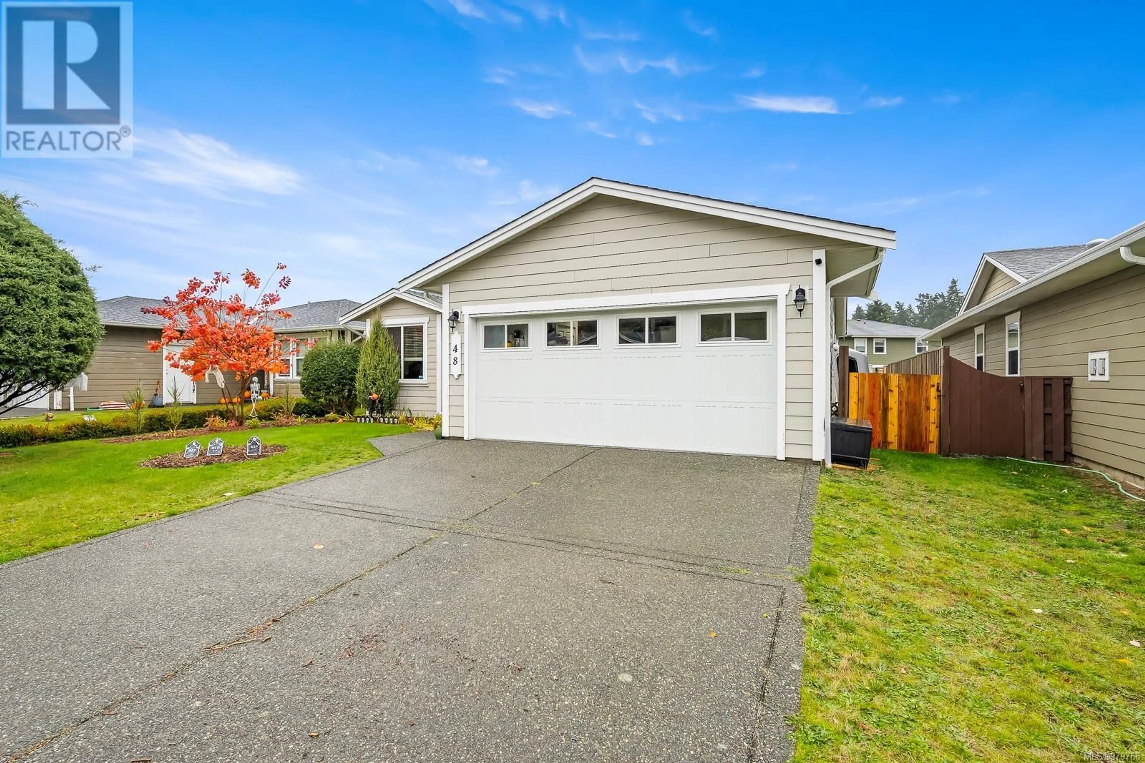 Frontside or backside of a home, the fenced backyard for 48 Strathcona Way, Campbell River British Columbia V9H1W3