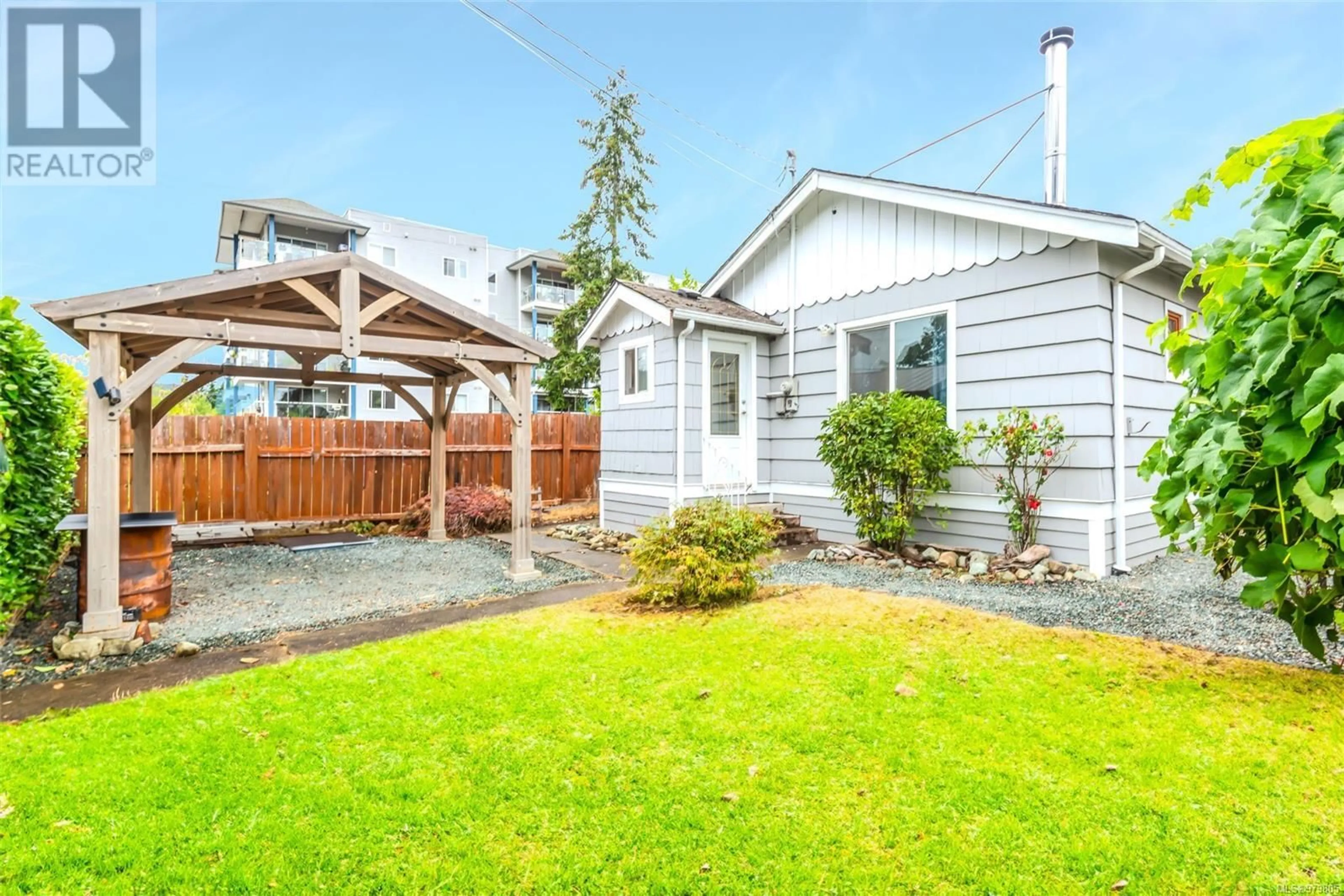 Frontside or backside of a home, the fenced backyard for 4917 Montrose St, Port Alberni British Columbia V9Y1M4