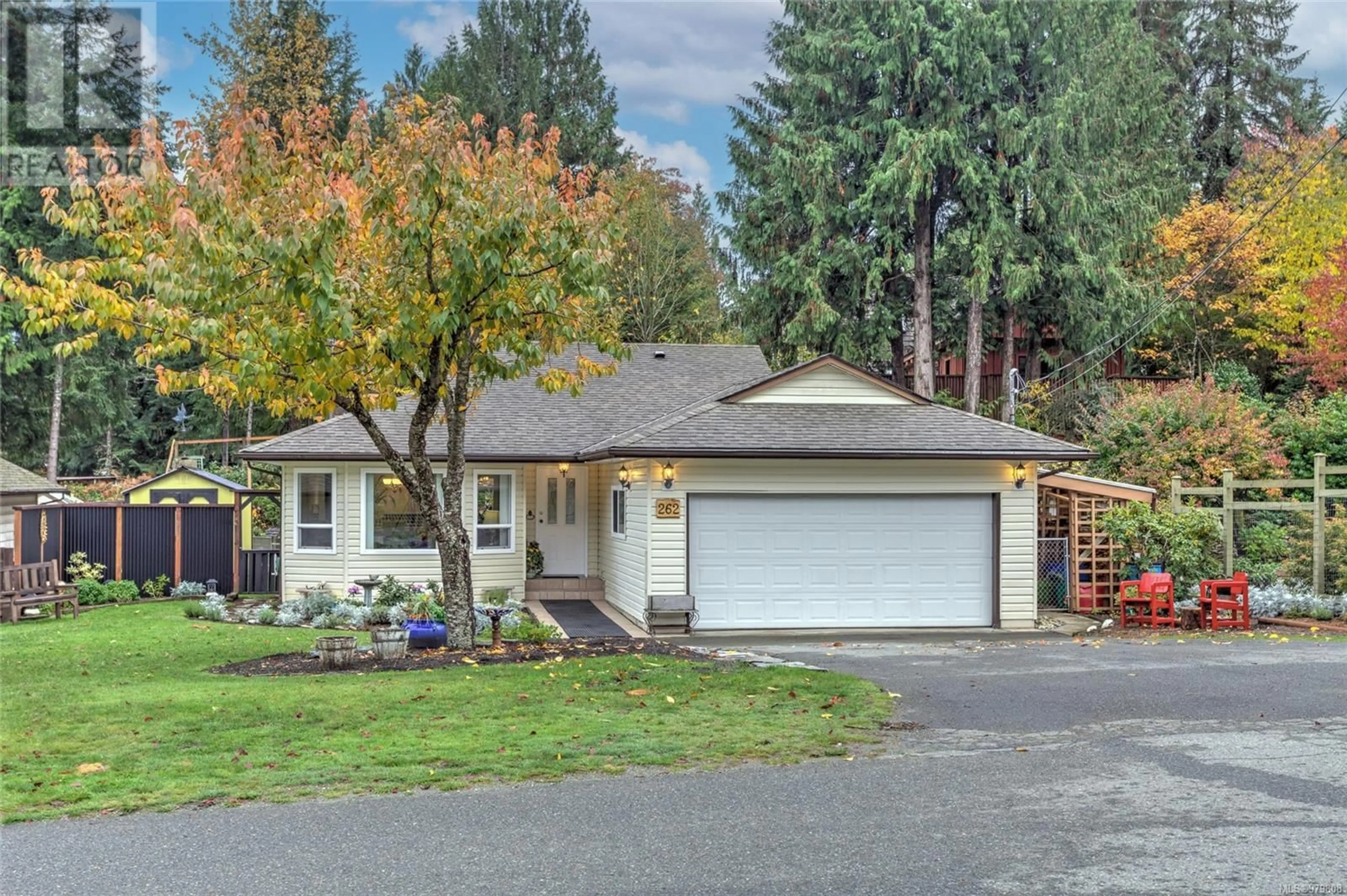 Frontside or backside of a home, the fenced backyard for 262 River Rd, Lake Cowichan British Columbia V0R2G0