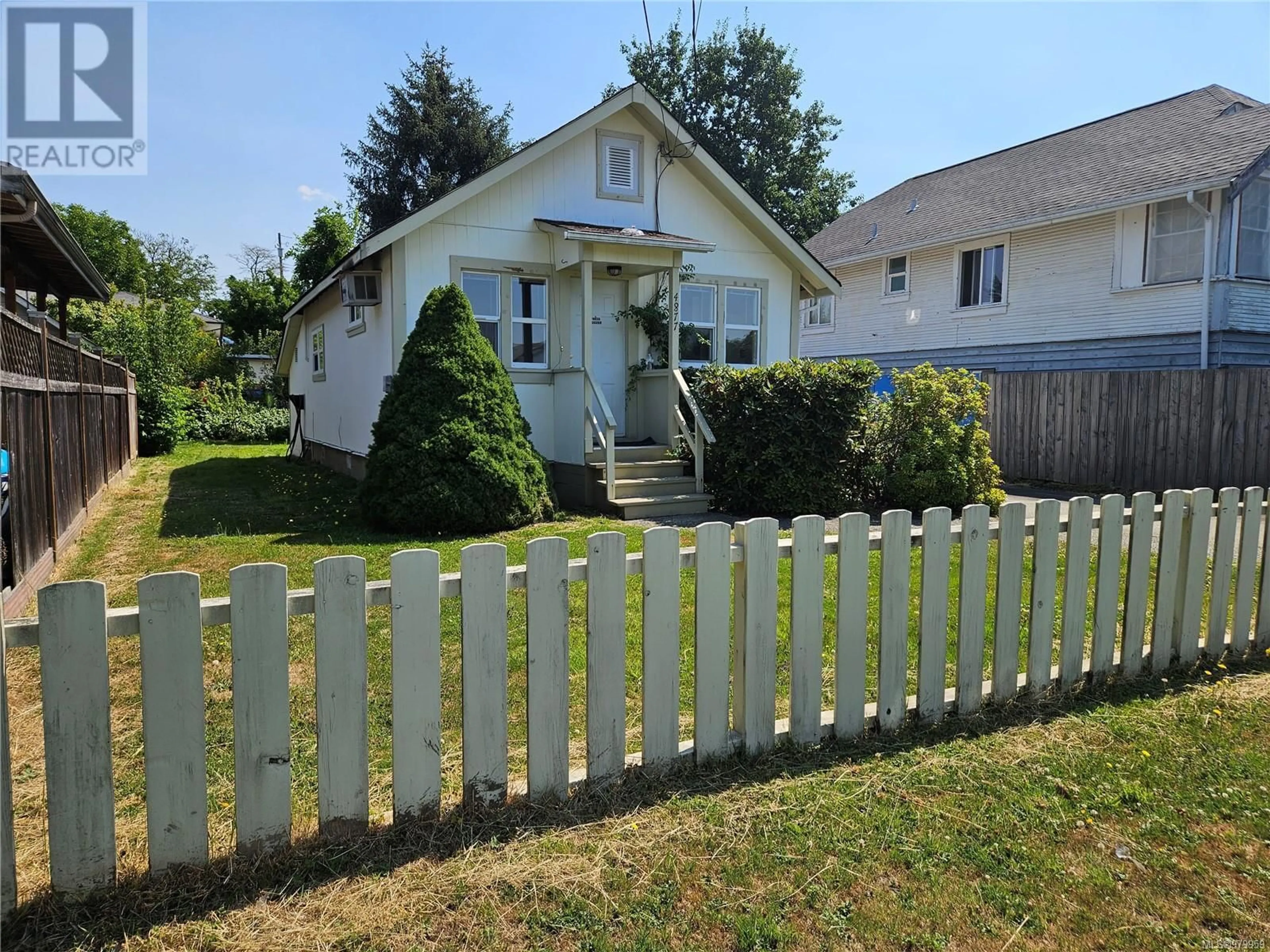 Frontside or backside of a home, the fenced backyard for 4877 Elizabeth St, Port Alberni British Columbia V9Y6M3