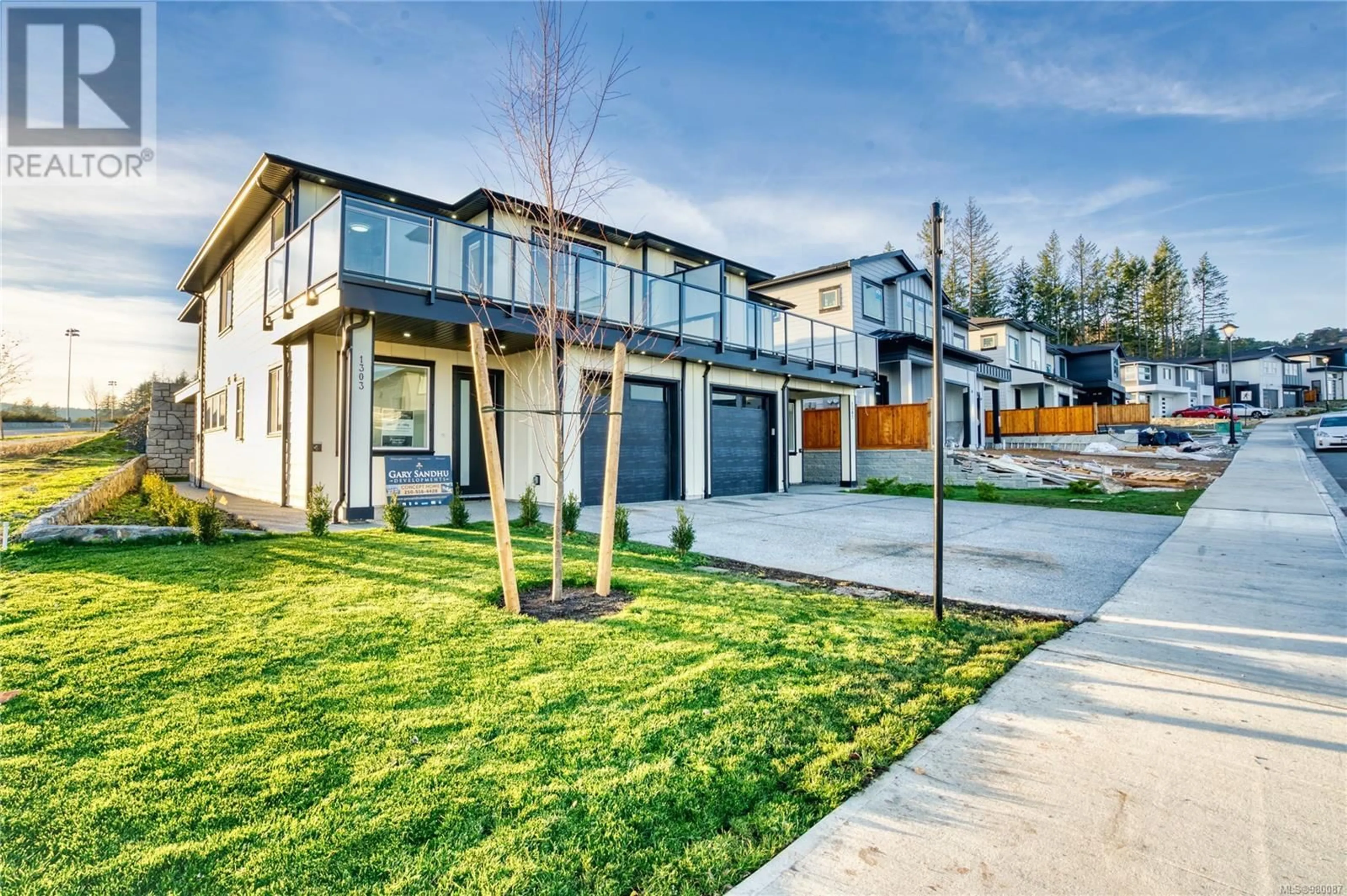 Frontside or backside of a home, the fenced backyard for 1303 Sandstone Lane, Langford British Columbia V9B5Y4