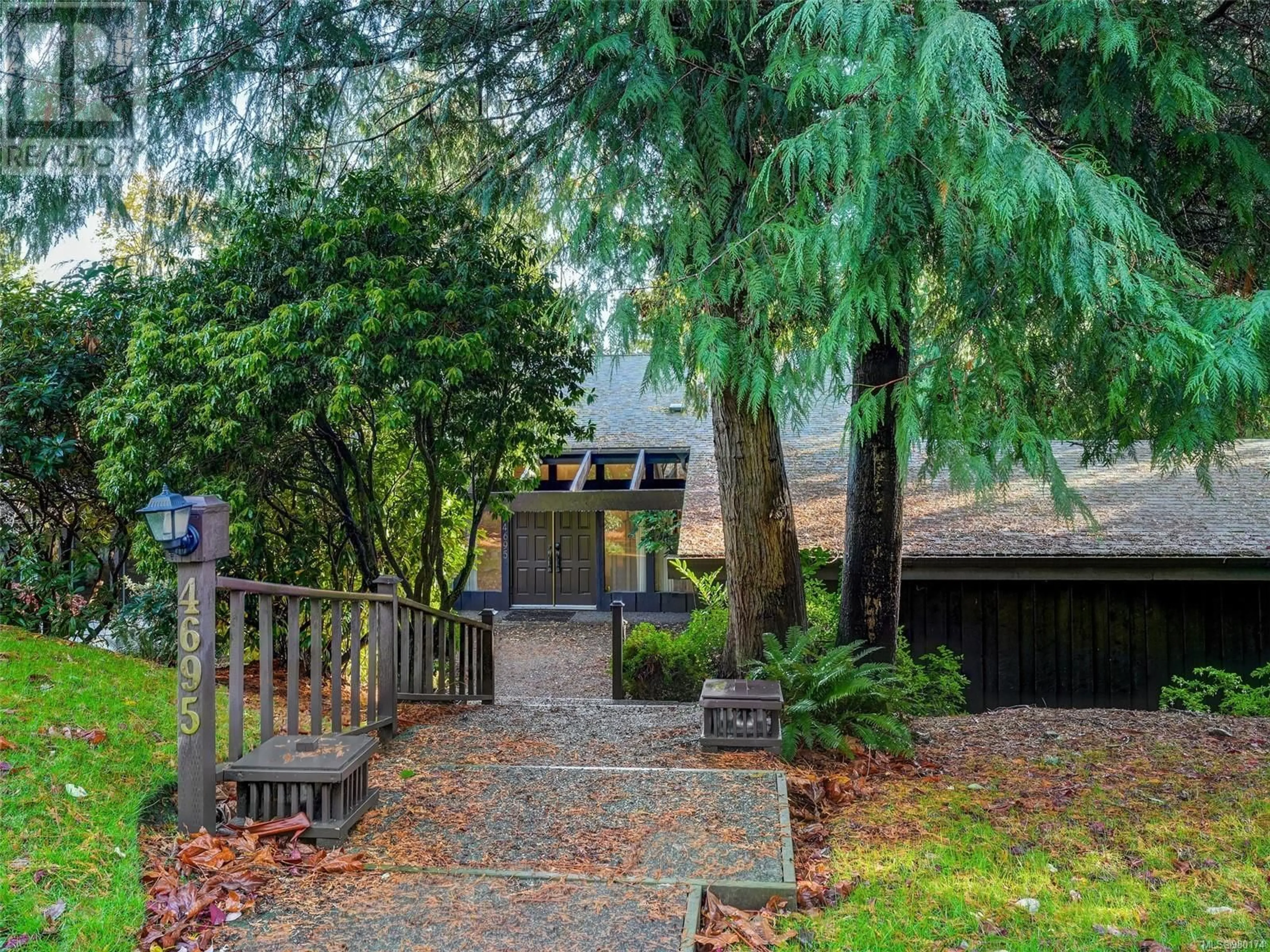 Frontside or backside of a home, the fenced backyard for 4695 Hillwood Rd, Saanich British Columbia V8Y2N3