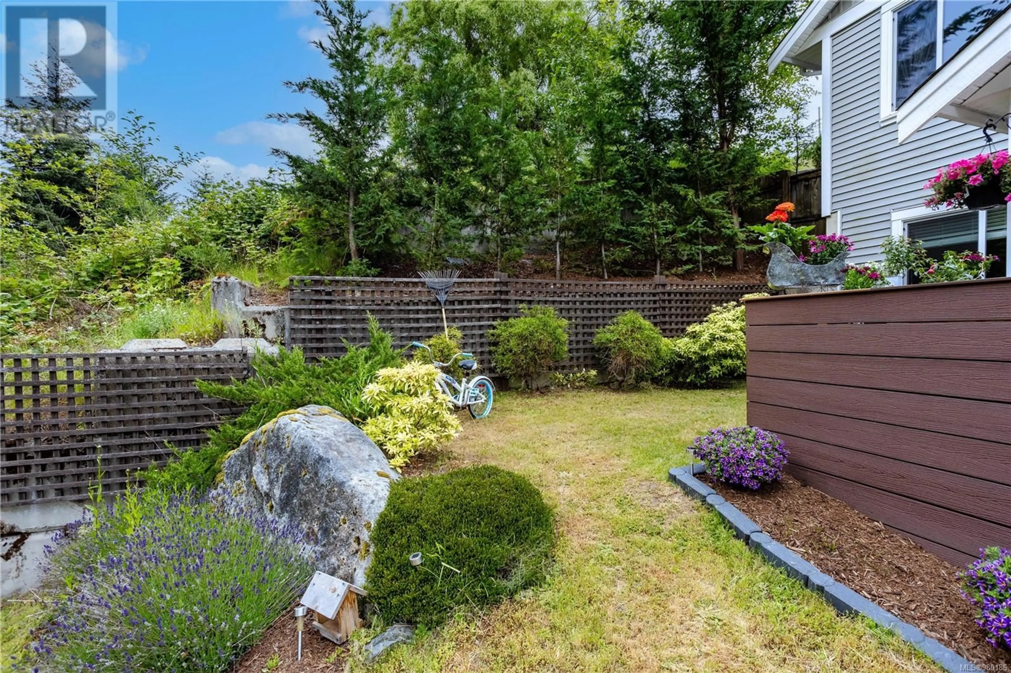 Patio, the fenced backyard for 5727 Bradbury Rd, Nanaimo British Columbia V9T0B6