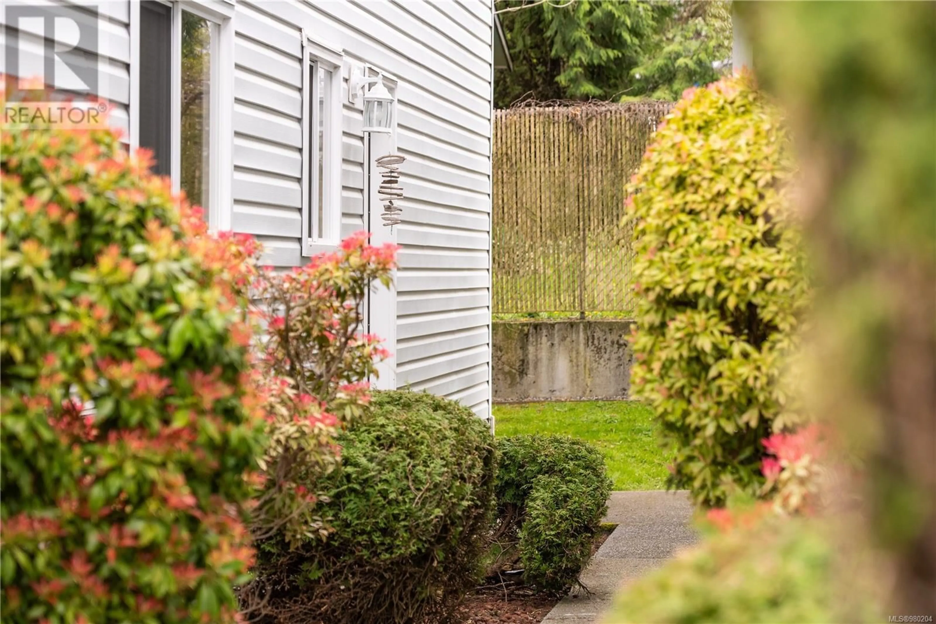 Frontside or backside of a home, the fenced backyard for 17 266 Harwell Rd, Nanaimo British Columbia V9R6V1