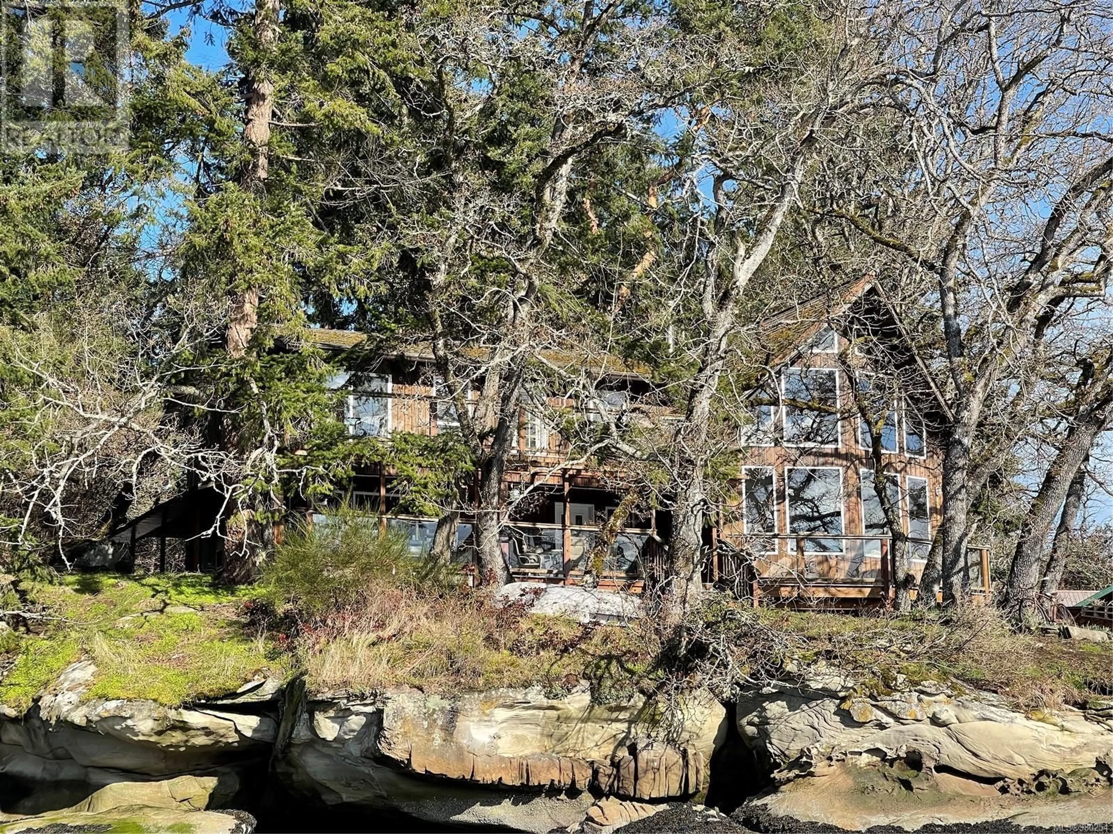 A pic from outside/outdoor area/front of a property/back of a property/a pic from drone, forest/trees view for 4 PIRATES LANE, Protection Island British Columbia V9R6R1