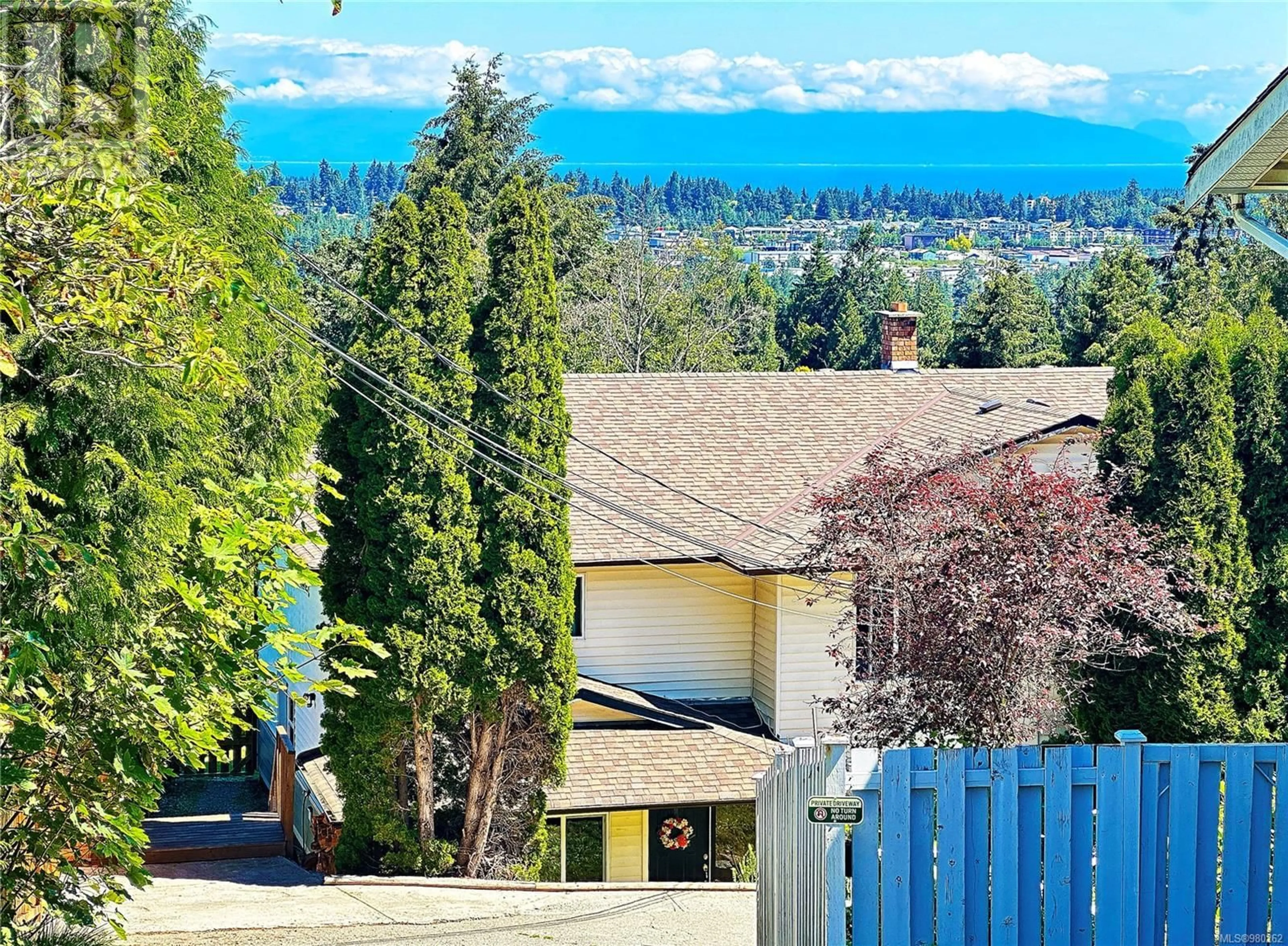 Frontside or backside of a home, the fenced backyard for 2326 Panorama View Dr, Nanaimo British Columbia V9R6T1