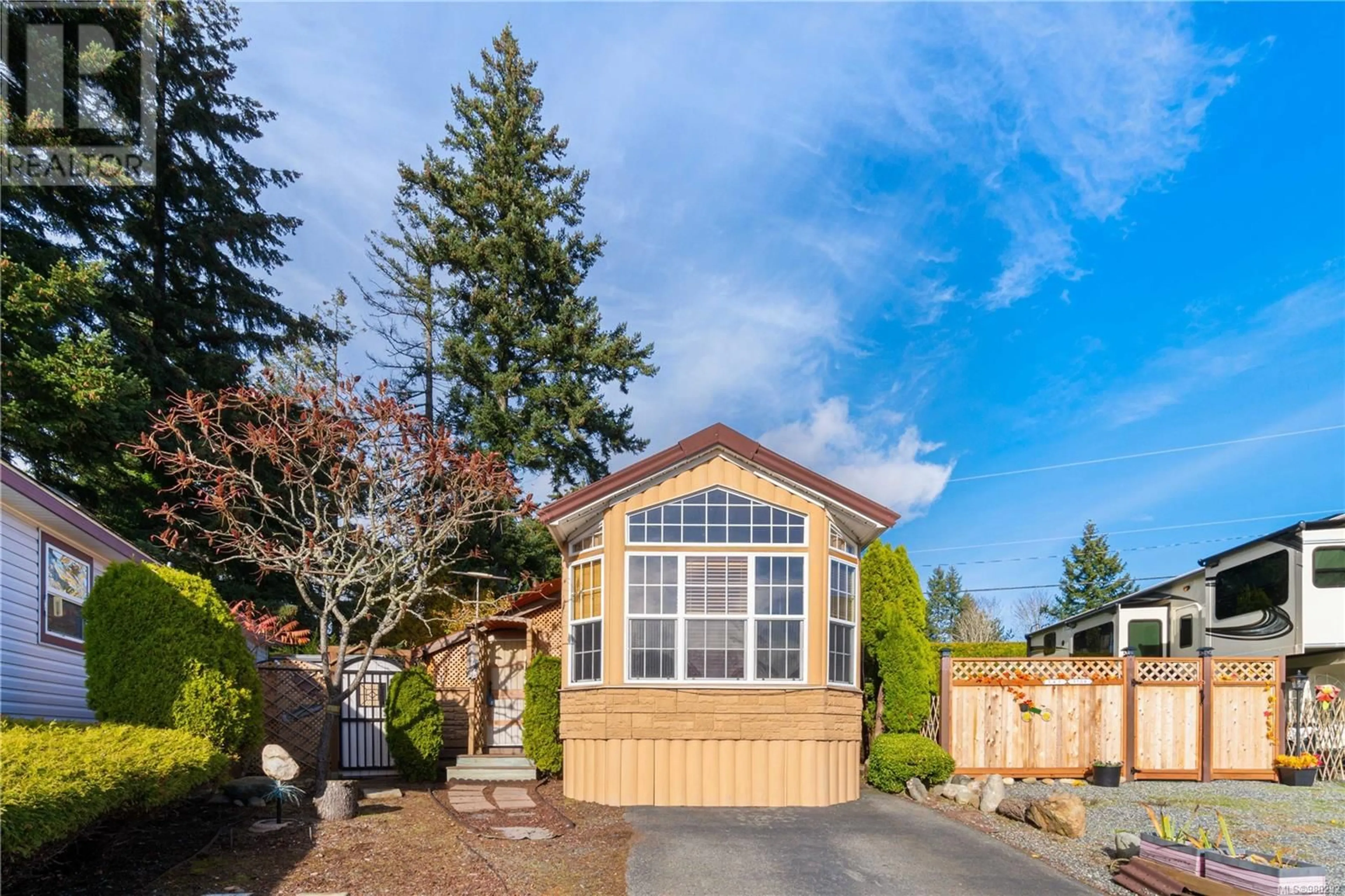 Frontside or backside of a home, the fenced backyard for 1106 Woss Lake Dr, Nanaimo British Columbia V9R6S8