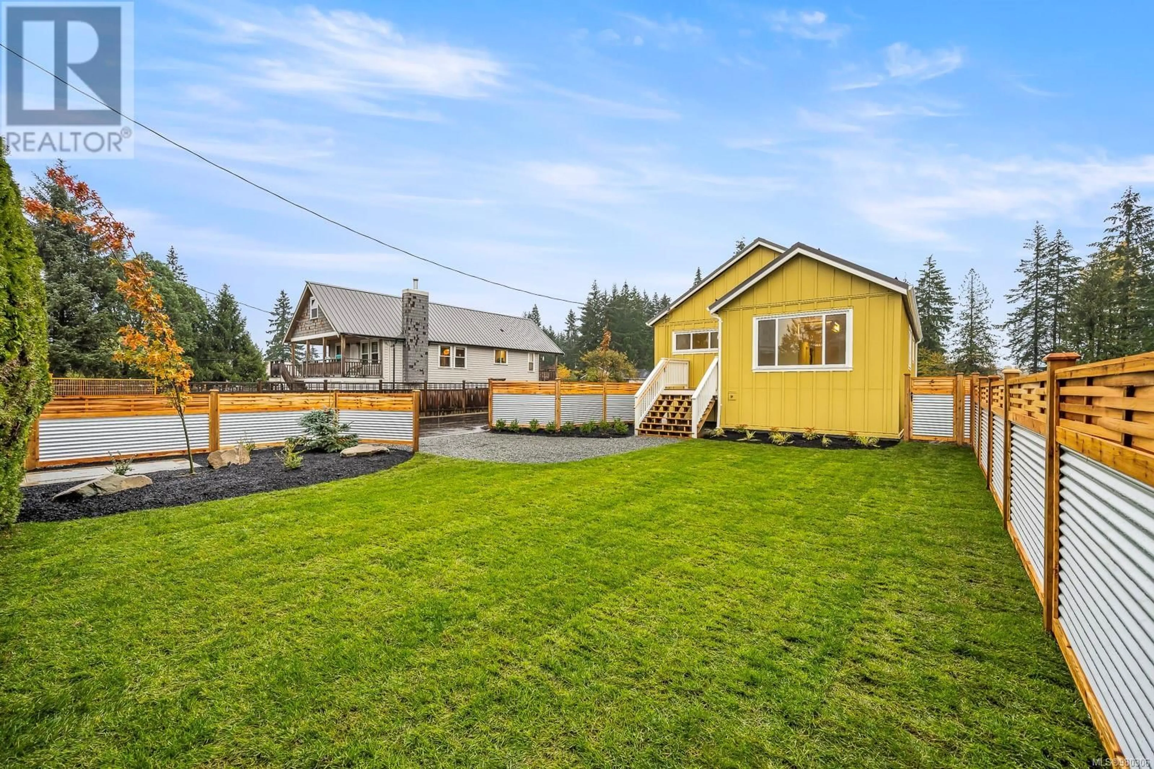 Frontside or backside of a home, the fenced backyard for SL3 4703 Cumberland Rd, Cumberland British Columbia V0R1S0