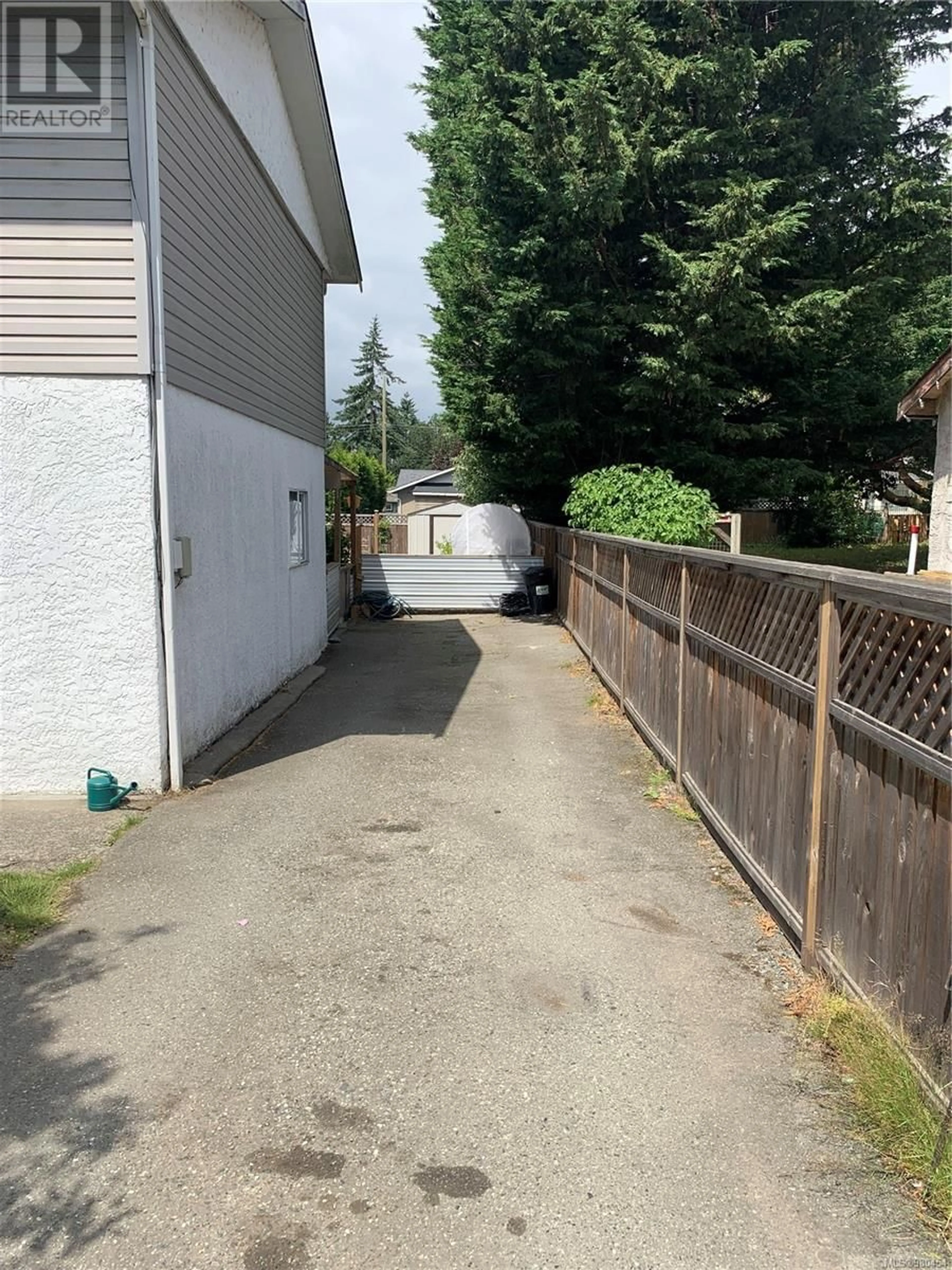 Frontside or backside of a home, the fenced backyard for 2832 Jacklin Rd, Langford British Columbia V9B3X9