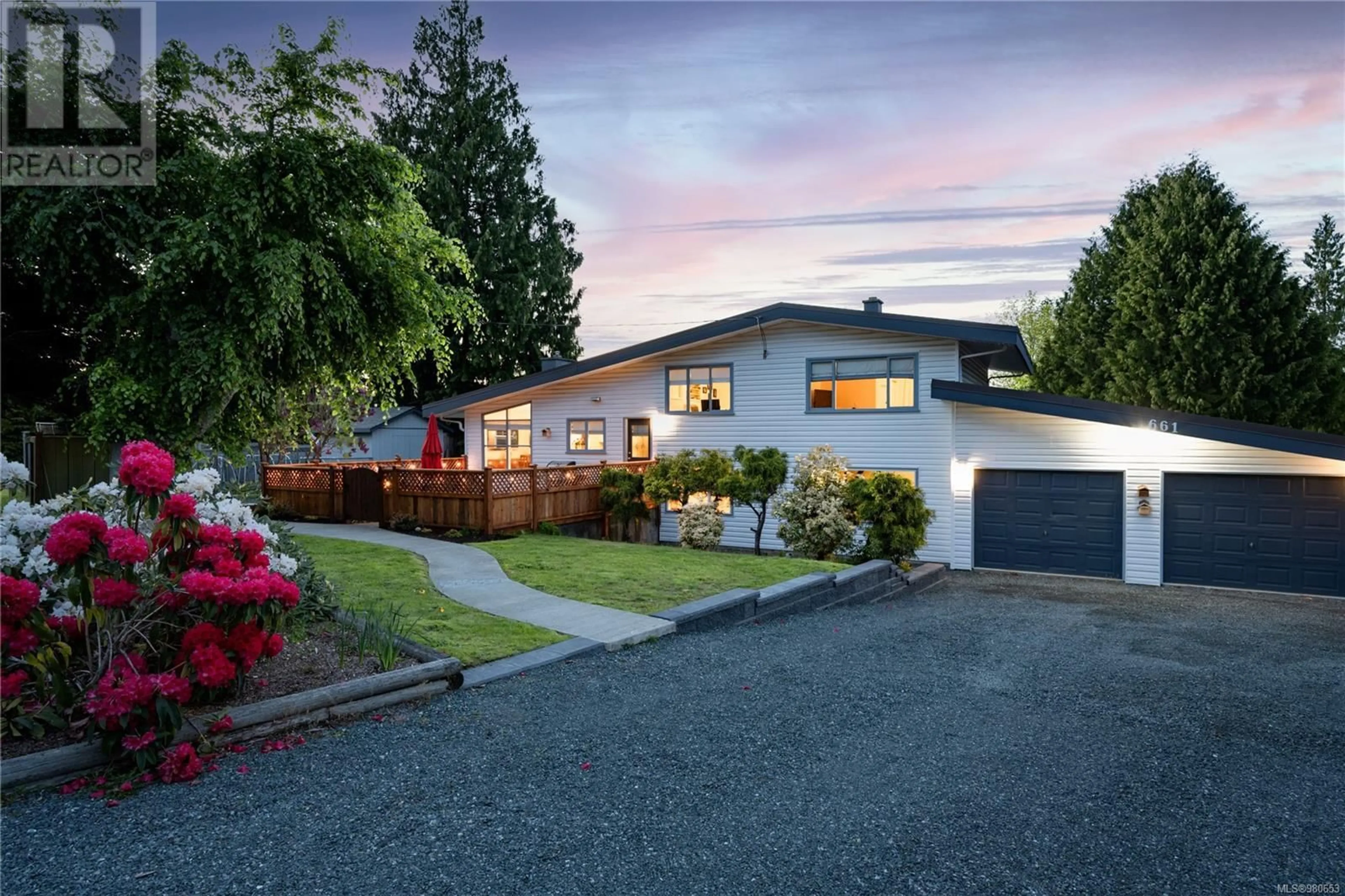 Frontside or backside of a home, the fenced backyard for 661 Belyea Rd, Qualicum Beach British Columbia V9K1H4