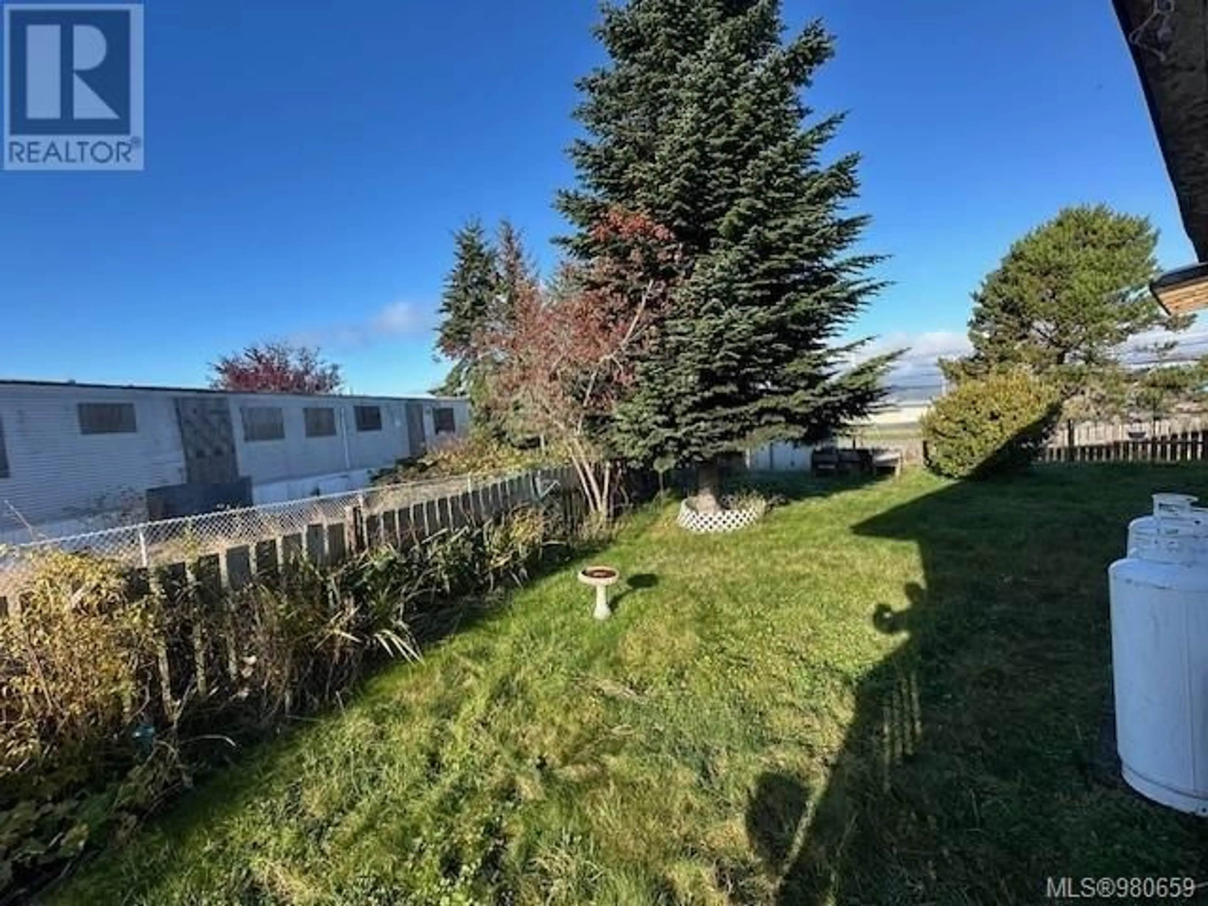 A pic from exterior of the house or condo, the fenced backyard for 2248 Camosun Cres, Port McNeill British Columbia V0N2R0