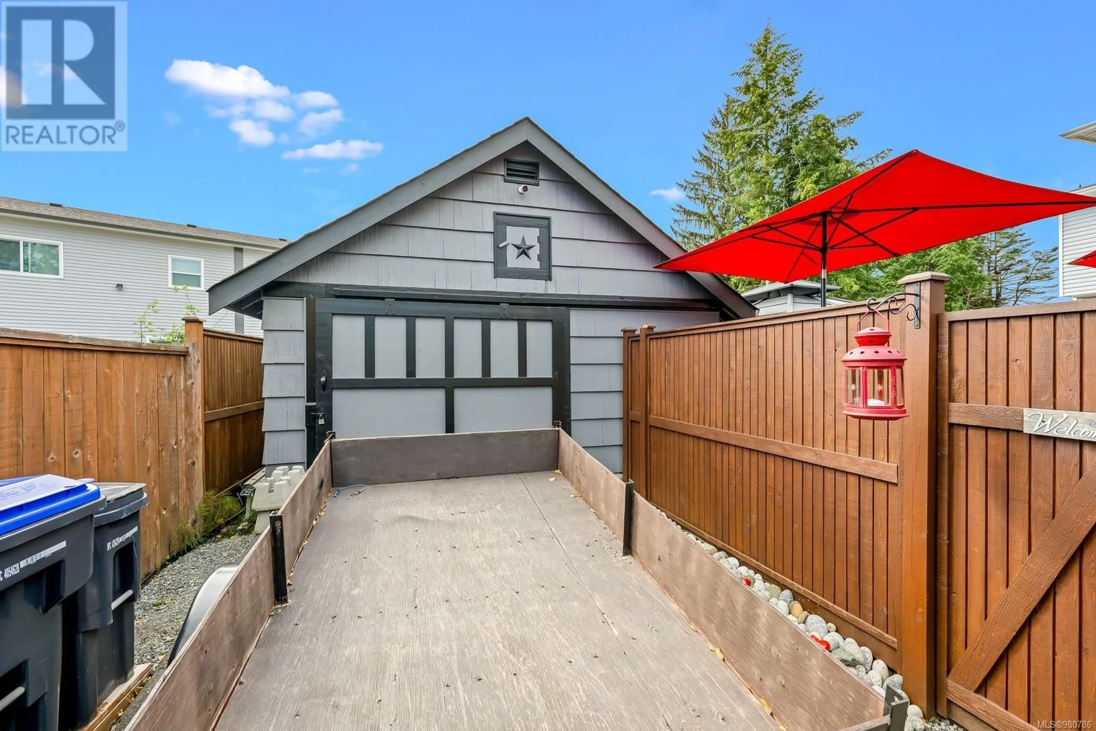 Frontside or backside of a home, the fenced backyard for 1040 Cumberland Rd, Courtenay British Columbia V9N2E6