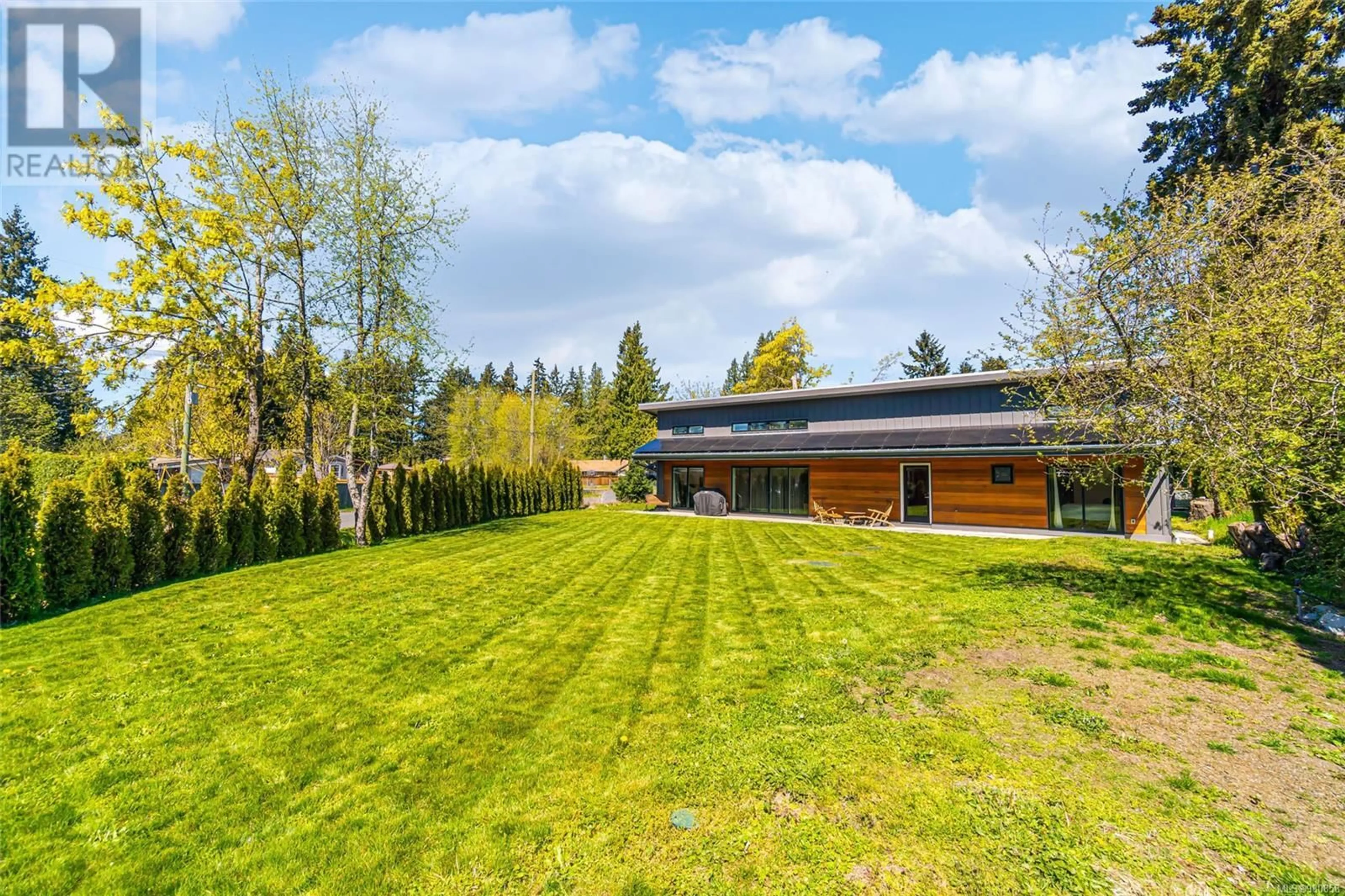 Frontside or backside of a home, the fenced backyard for 2359 Gould Rd E, Nanaimo British Columbia V9X1K1