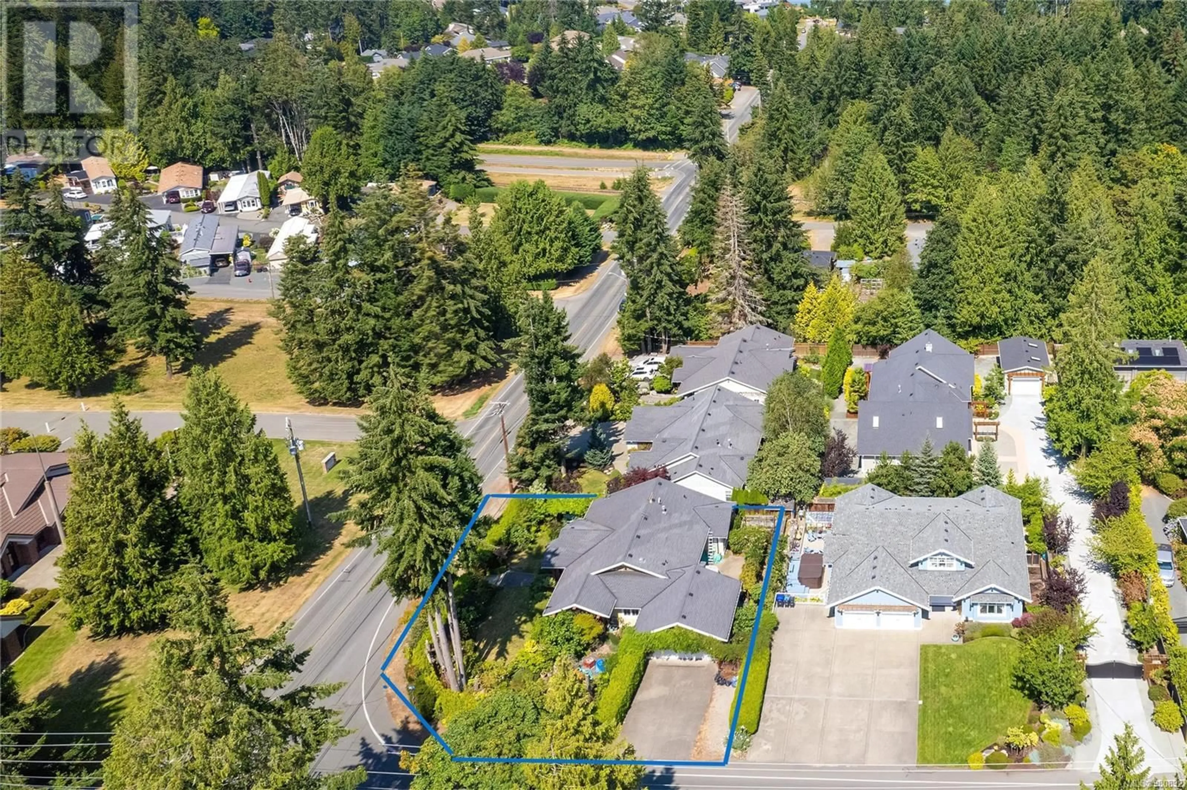 A pic from exterior of the house or condo, the fenced backyard for 598 Arbutus St, Qualicum Beach British Columbia V9K1K6