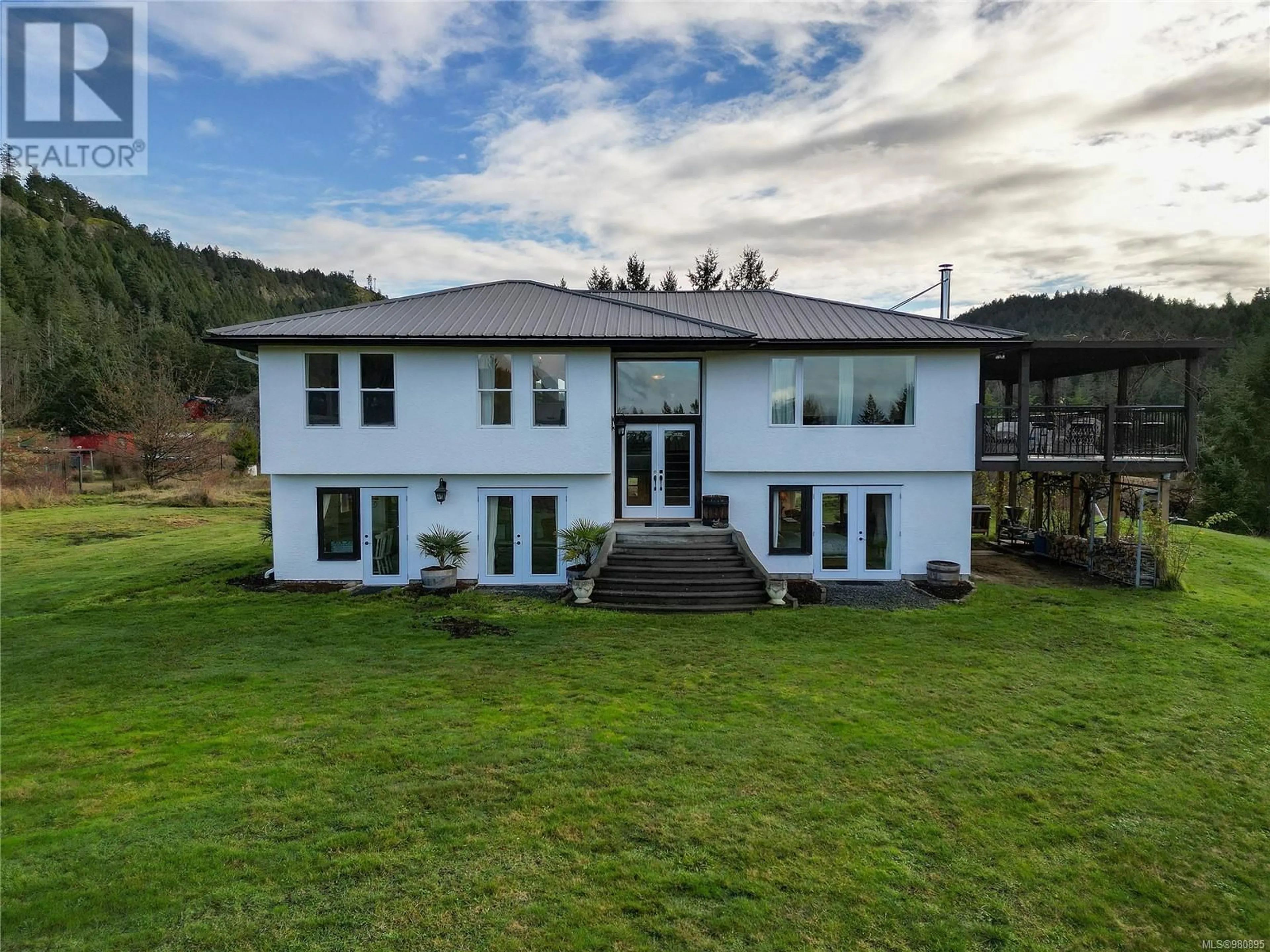 Frontside or backside of a home, the front or back of building for 300 Wood Dale Dr, Mayne Island British Columbia V0N2J2