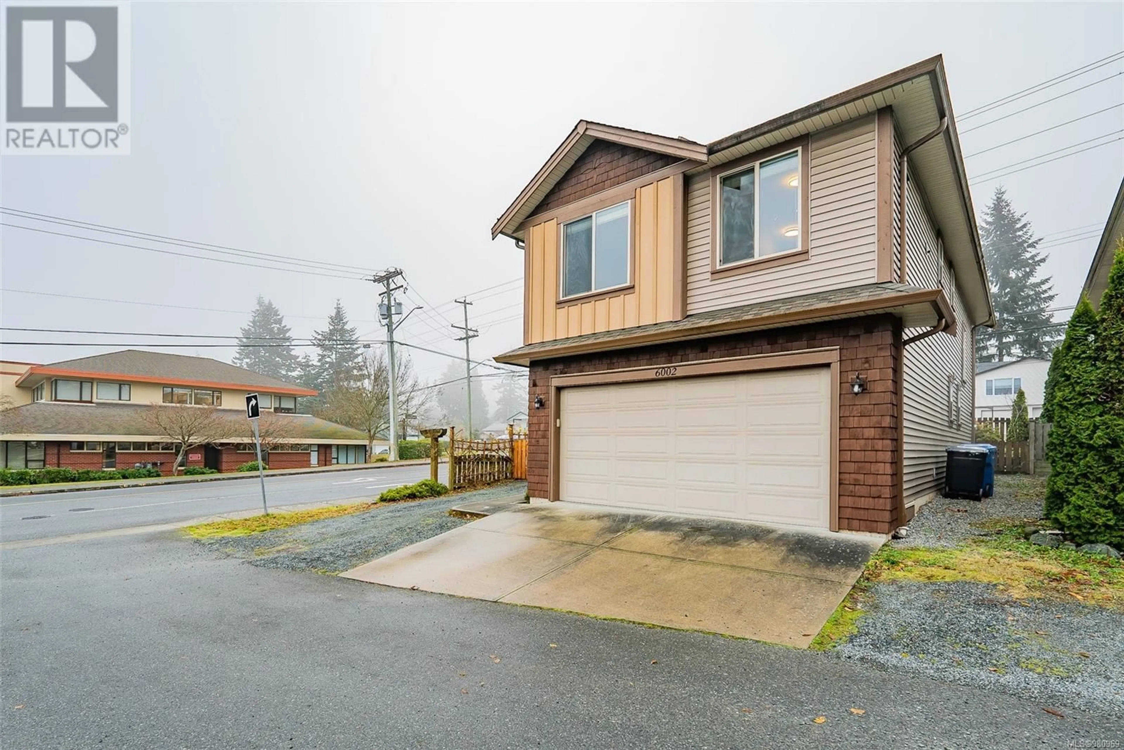 Frontside or backside of a home, the street view for 6002 Hammond Bay Rd, Nanaimo British Columbia V9T5M5