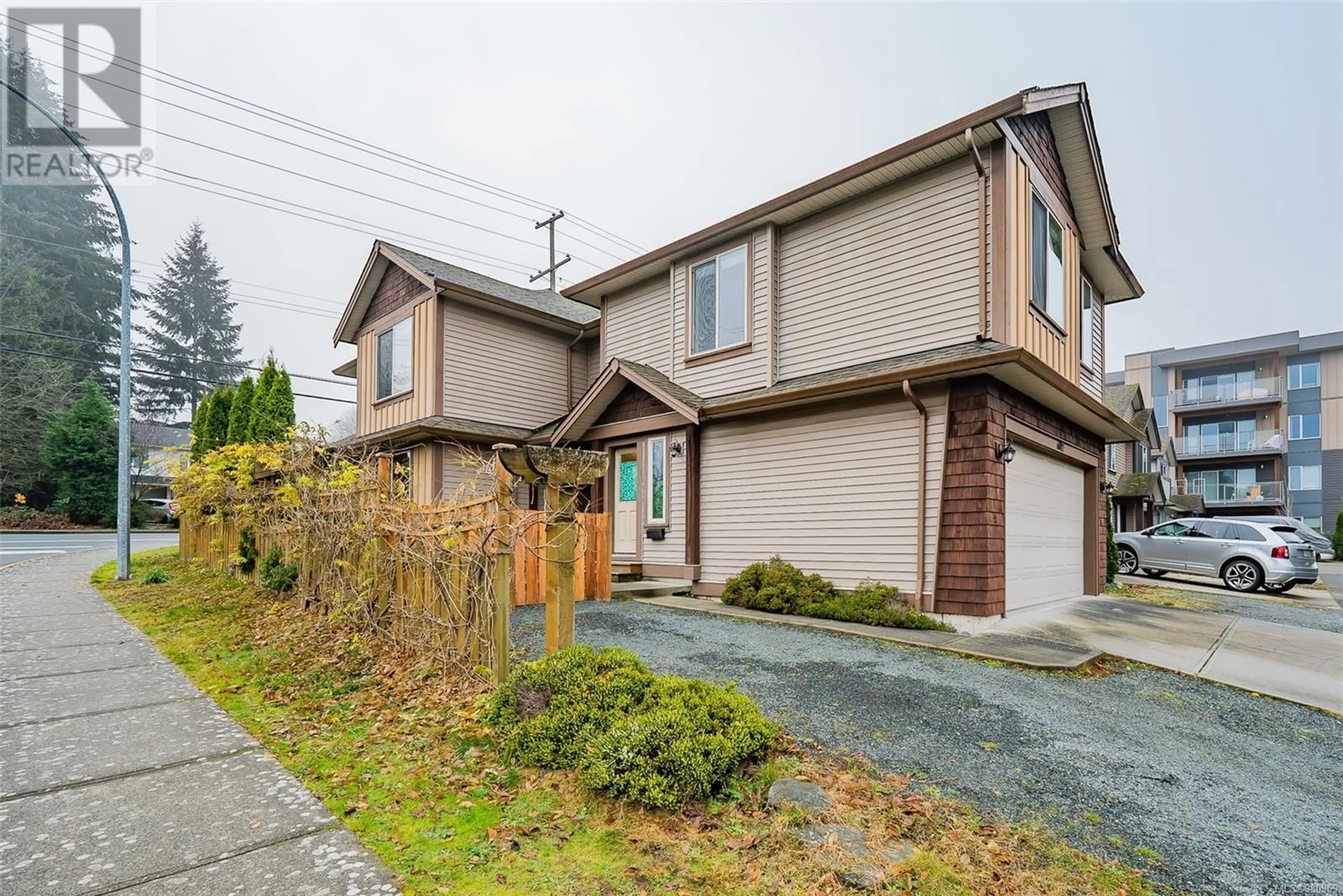 Frontside or backside of a home, the fenced backyard for 6002 Hammond Bay Rd, Nanaimo British Columbia V9T5M5