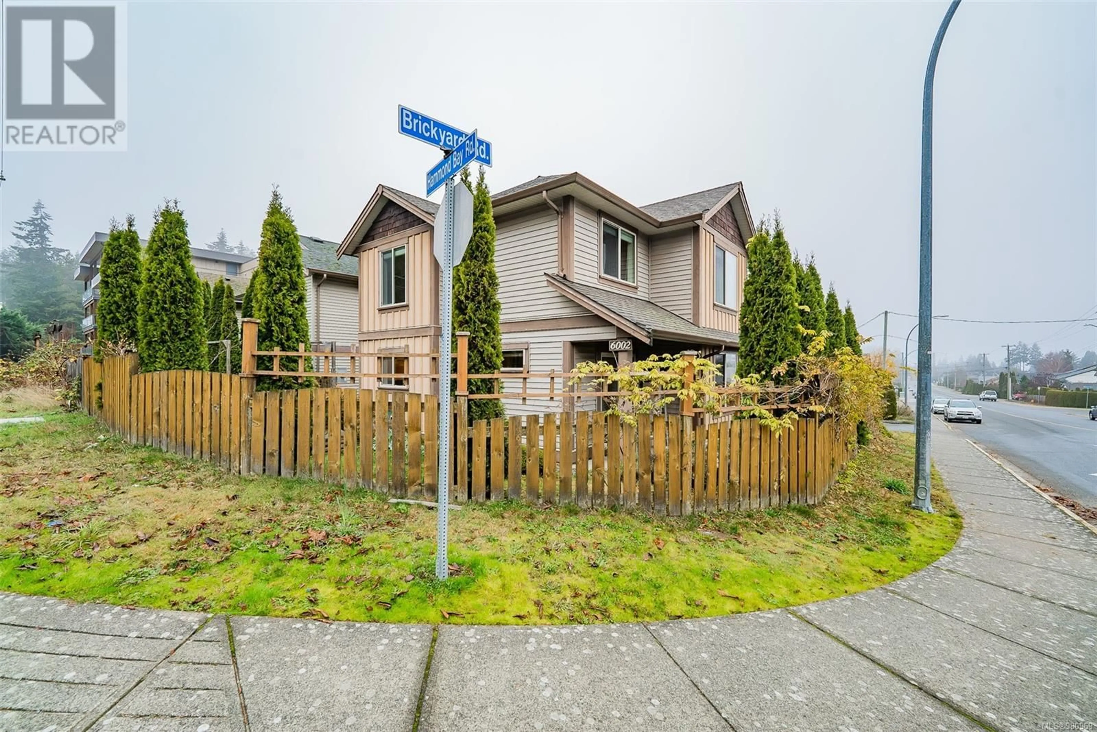 A pic from exterior of the house or condo, the fenced backyard for 6002 Hammond Bay Rd, Nanaimo British Columbia V9T5M5