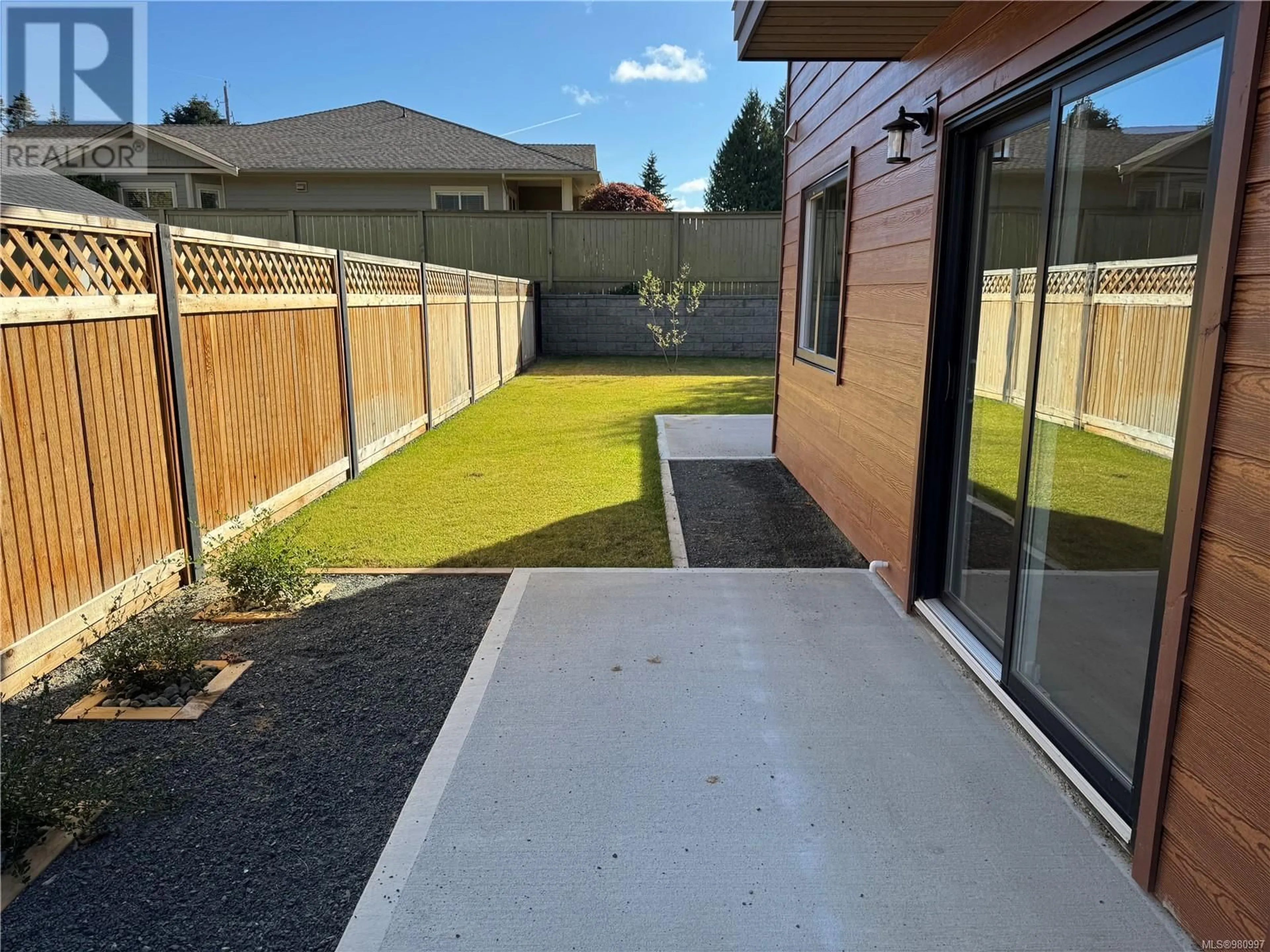 Patio, the fenced backyard for SL3 151 Shelly Rd, Parksville British Columbia V9P1T7