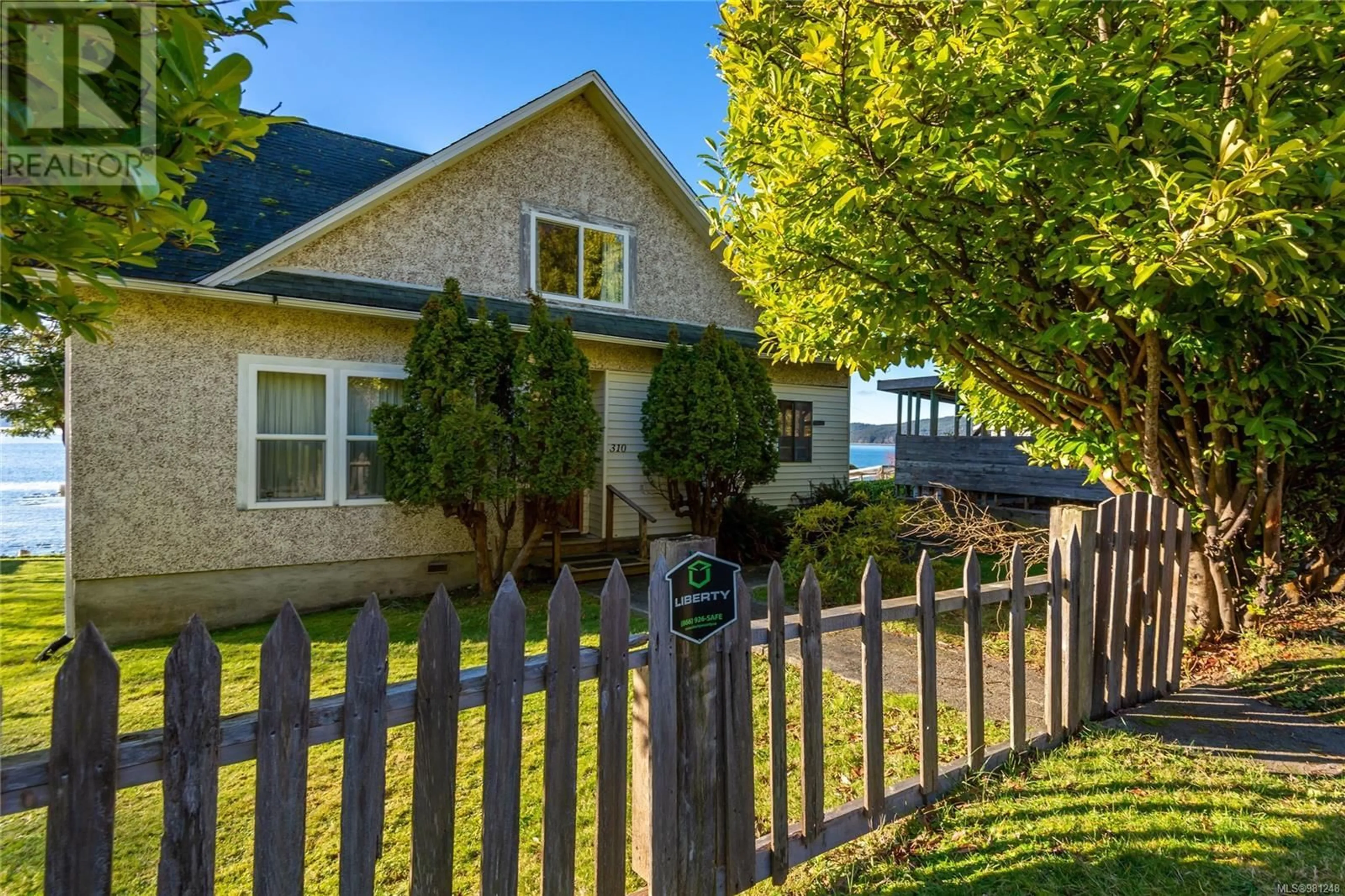 Frontside or backside of a home, the fenced backyard for 310 1st St, Sointula British Columbia V0N3E0