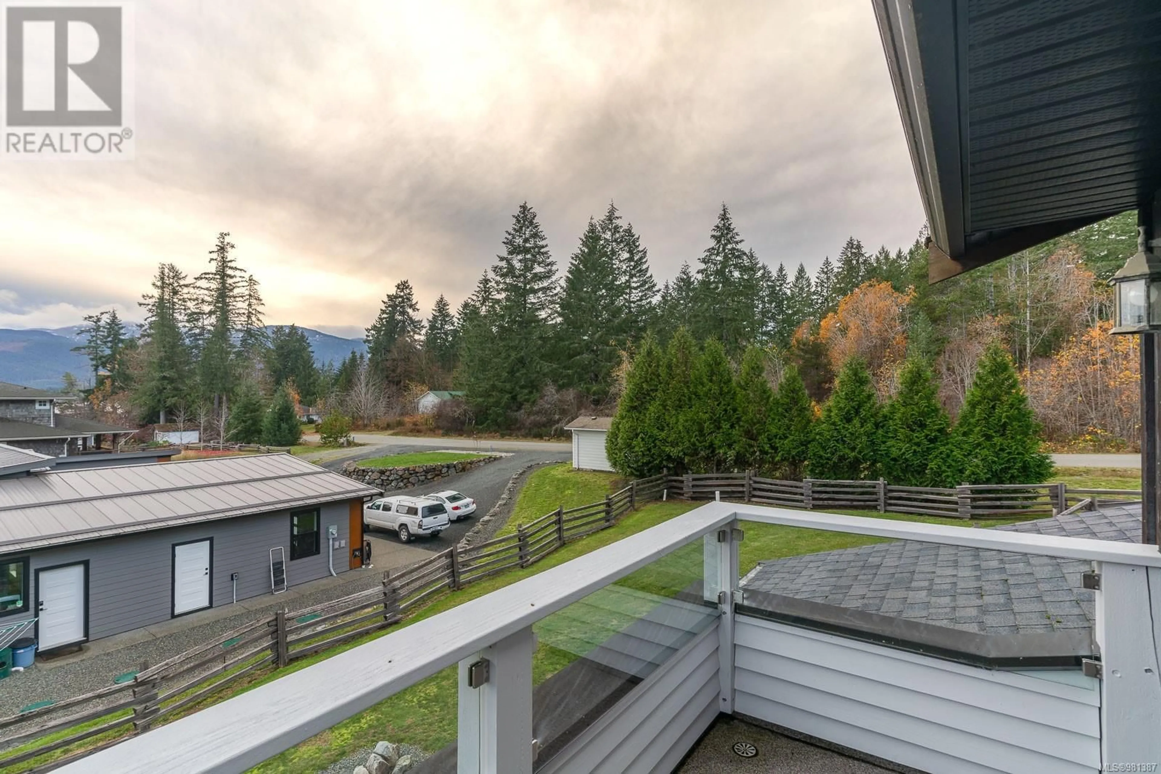 A pic from exterior of the house or condo, the fenced backyard for 6373 Salal Rd, Port Alberni British Columbia V9Y8Z3