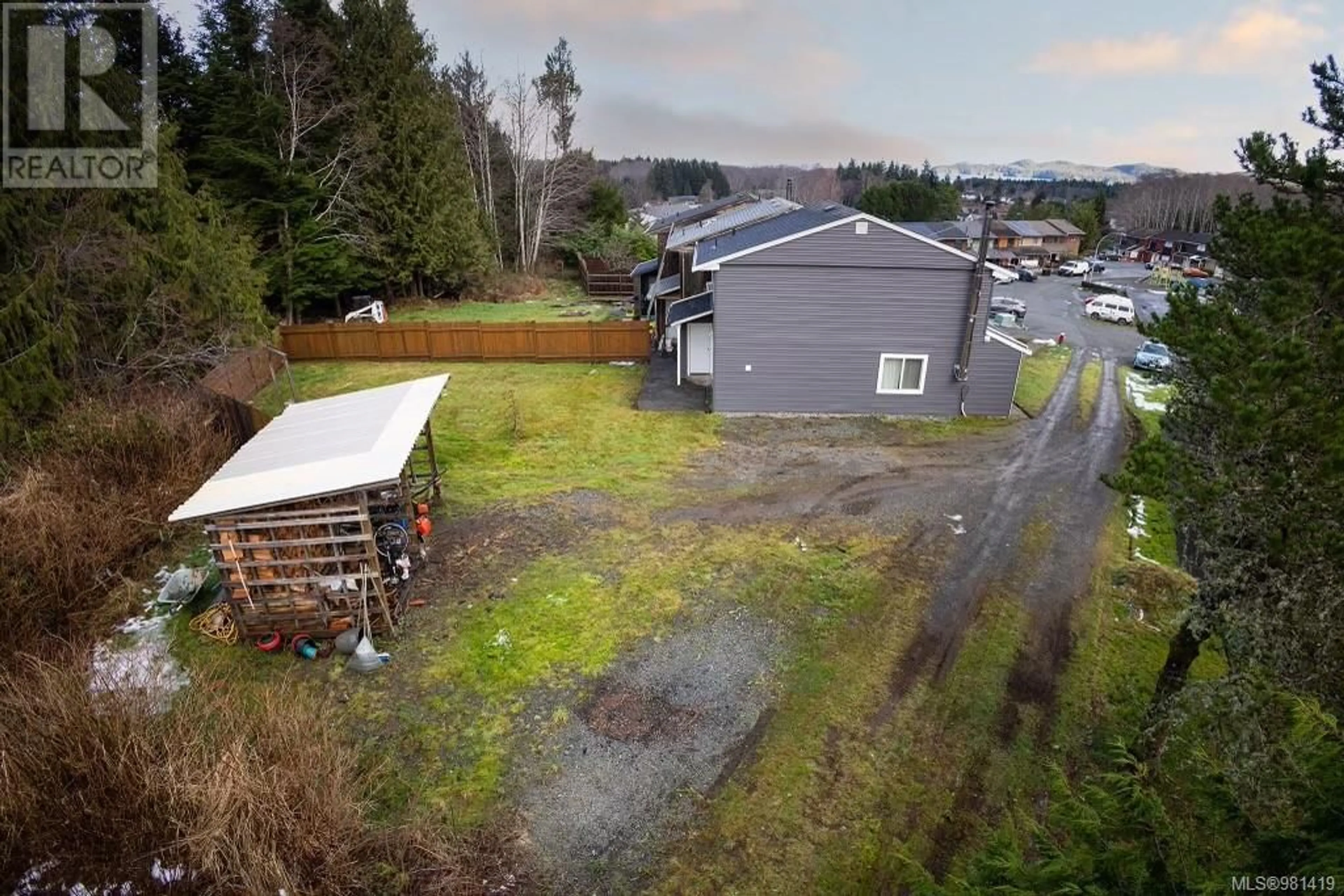 Frontside or backside of a home, the fenced backyard for 25 9560 Carnarvon Pl, Port Hardy British Columbia V0N2P0