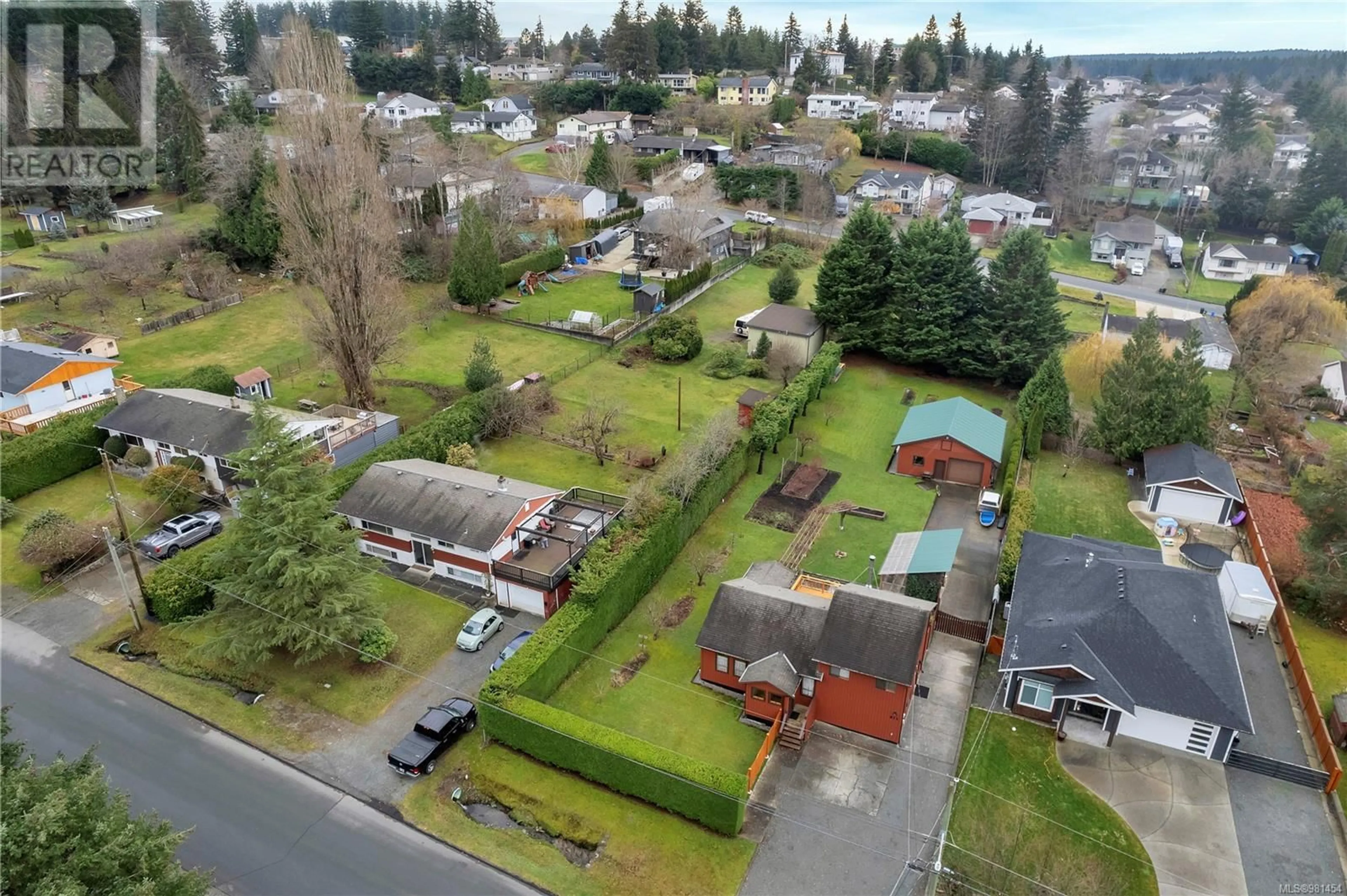 Frontside or backside of a home, the fenced backyard for 811 Nicholls Rd, Campbell River British Columbia V9W3P7