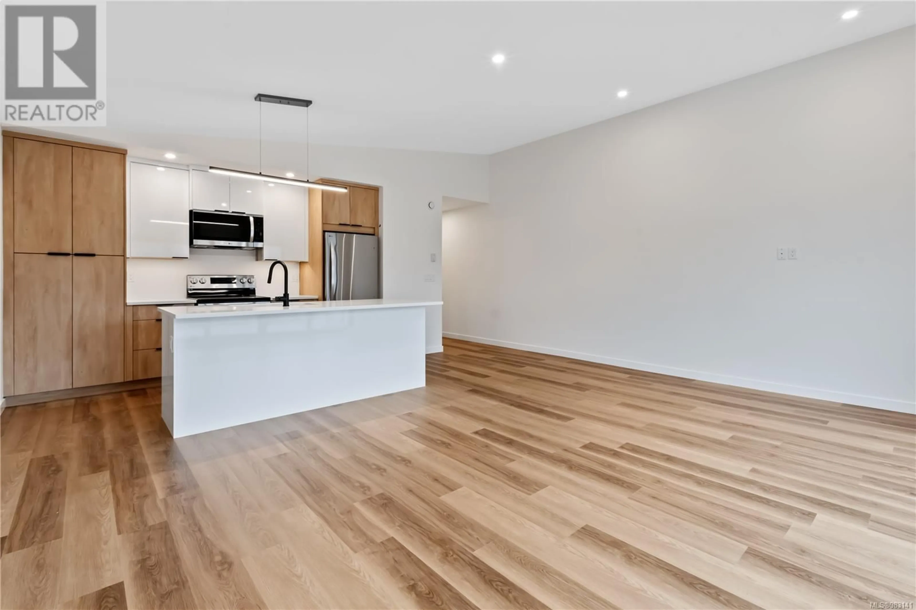 Open concept kitchen, wood/laminate floor for 201 1683 Larch Rd, Ucluelet British Columbia V0R3A0