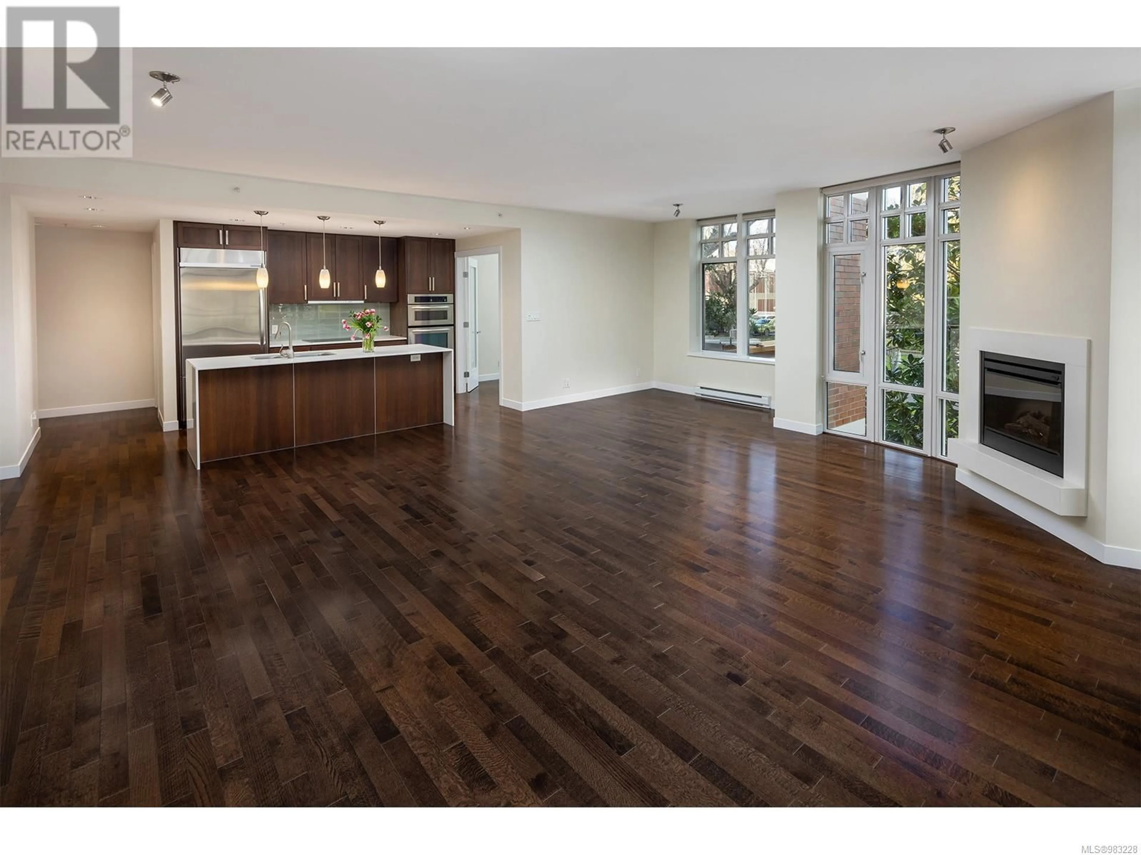 Open concept kitchen, wood/laminate floor for 306 999 Burdett Ave, Victoria British Columbia V8V3G7