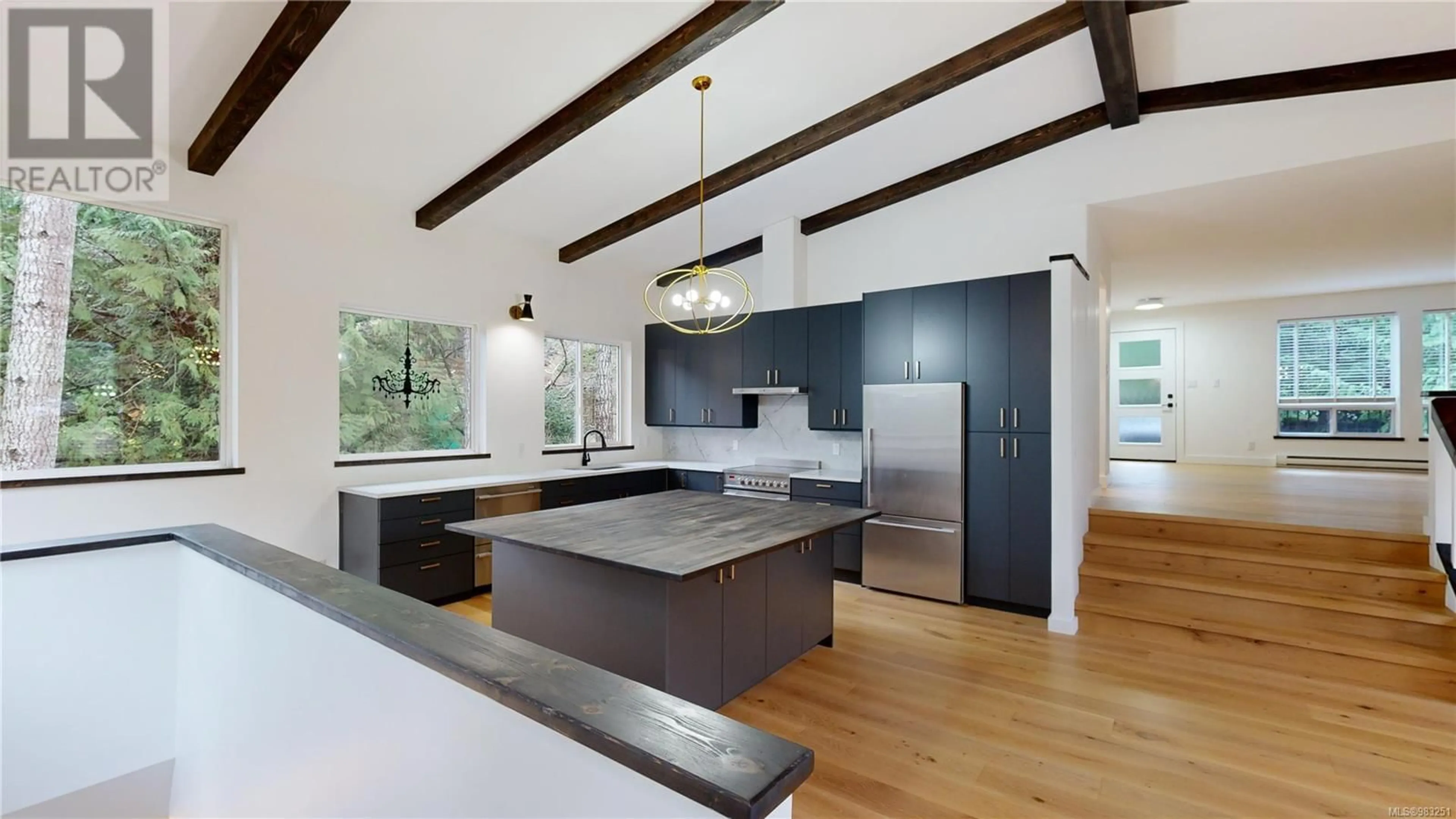 Open concept kitchen, wood/laminate floor for 750 Clarendon Rd, Gabriola Island British Columbia V0R1X1