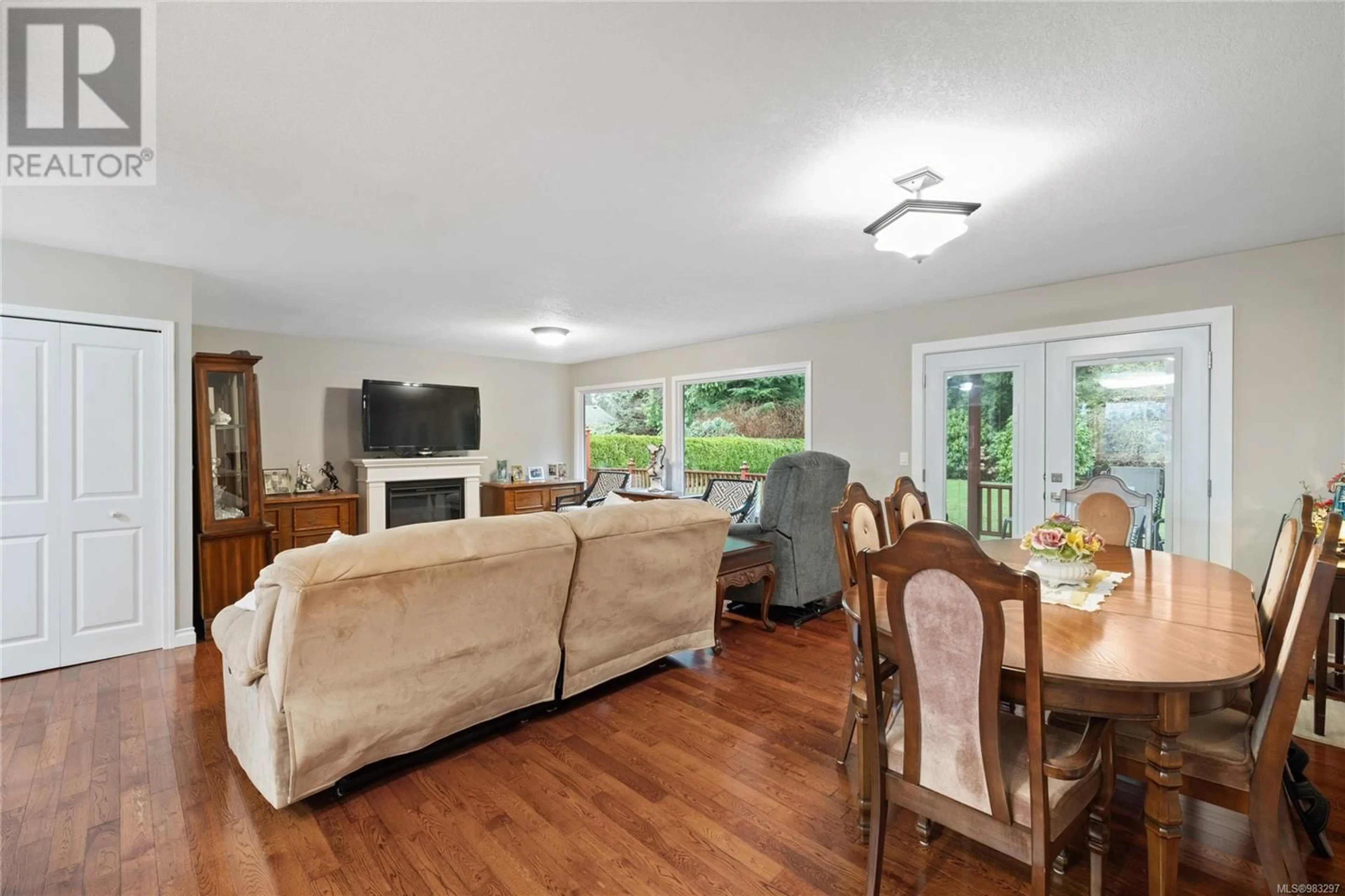 Living room with furniture, wood/laminate floor for 1310 Lanyon Dr, French Creek British Columbia V9P1W6