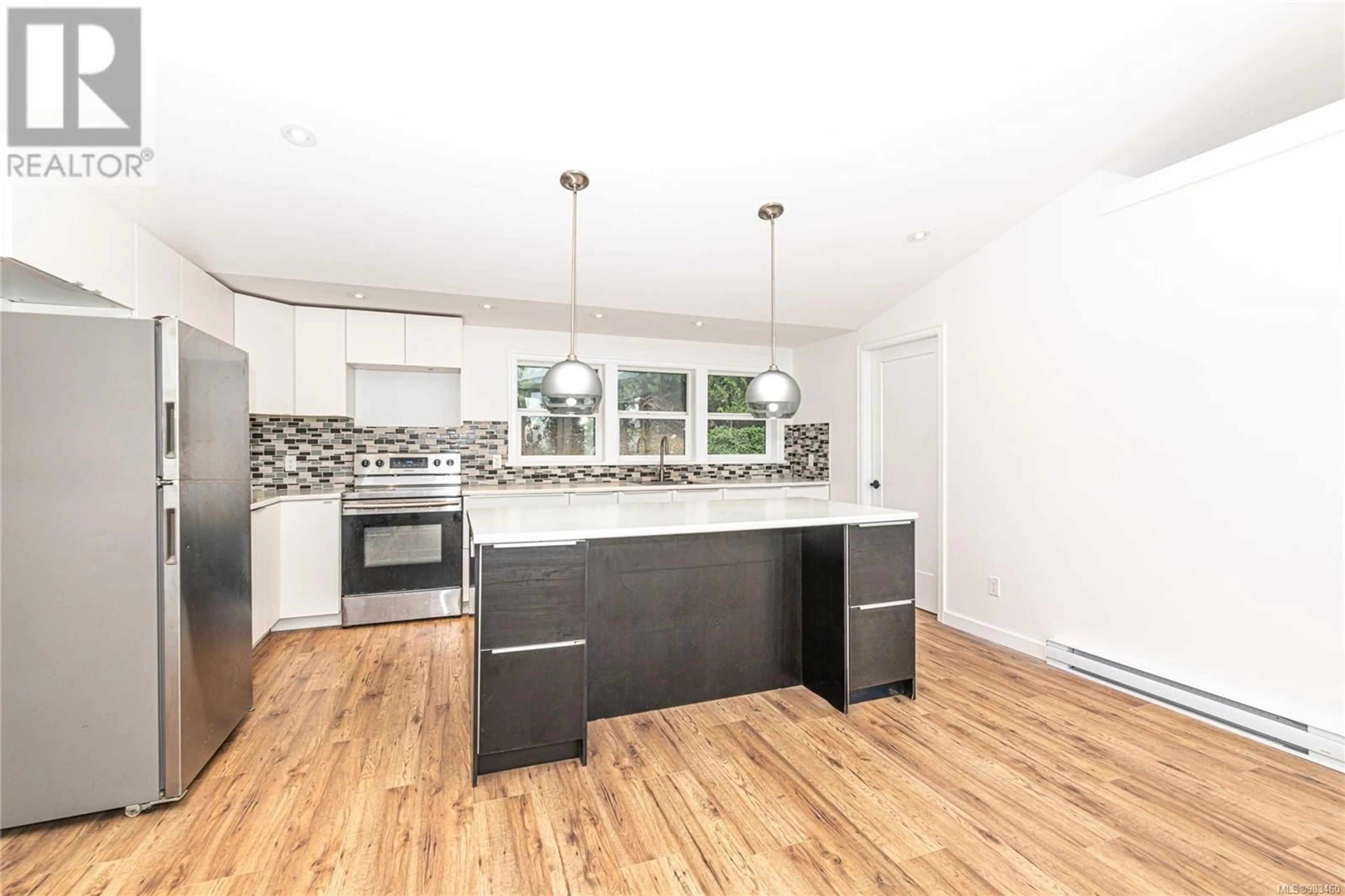 Open concept kitchen, wood/laminate floor for 879 Rainbow Rd, Salt Spring British Columbia V8K2M8