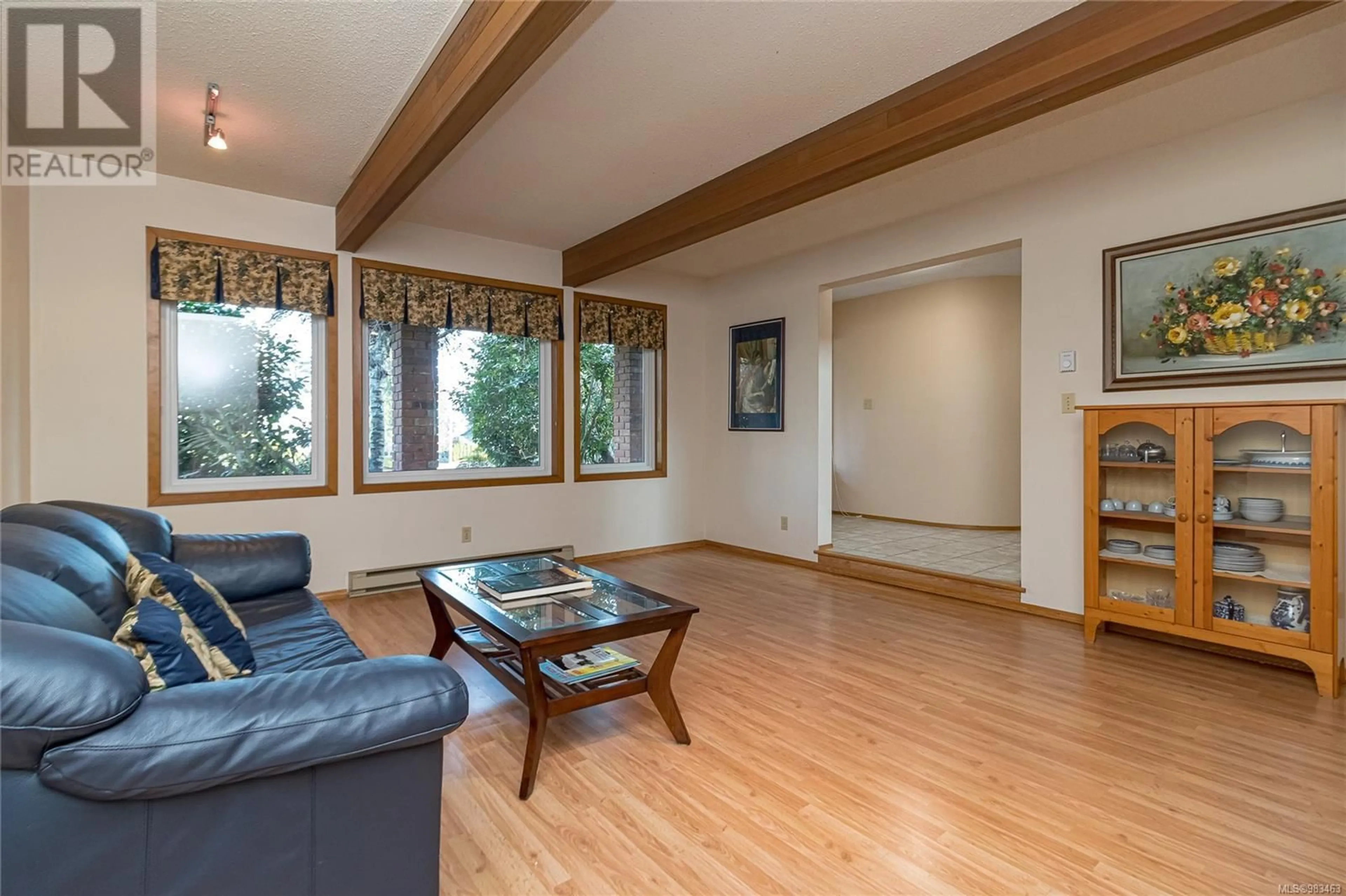 Living room with furniture, wood/laminate floor for 4475 Greentree Terr, Saanich British Columbia V8N3S9