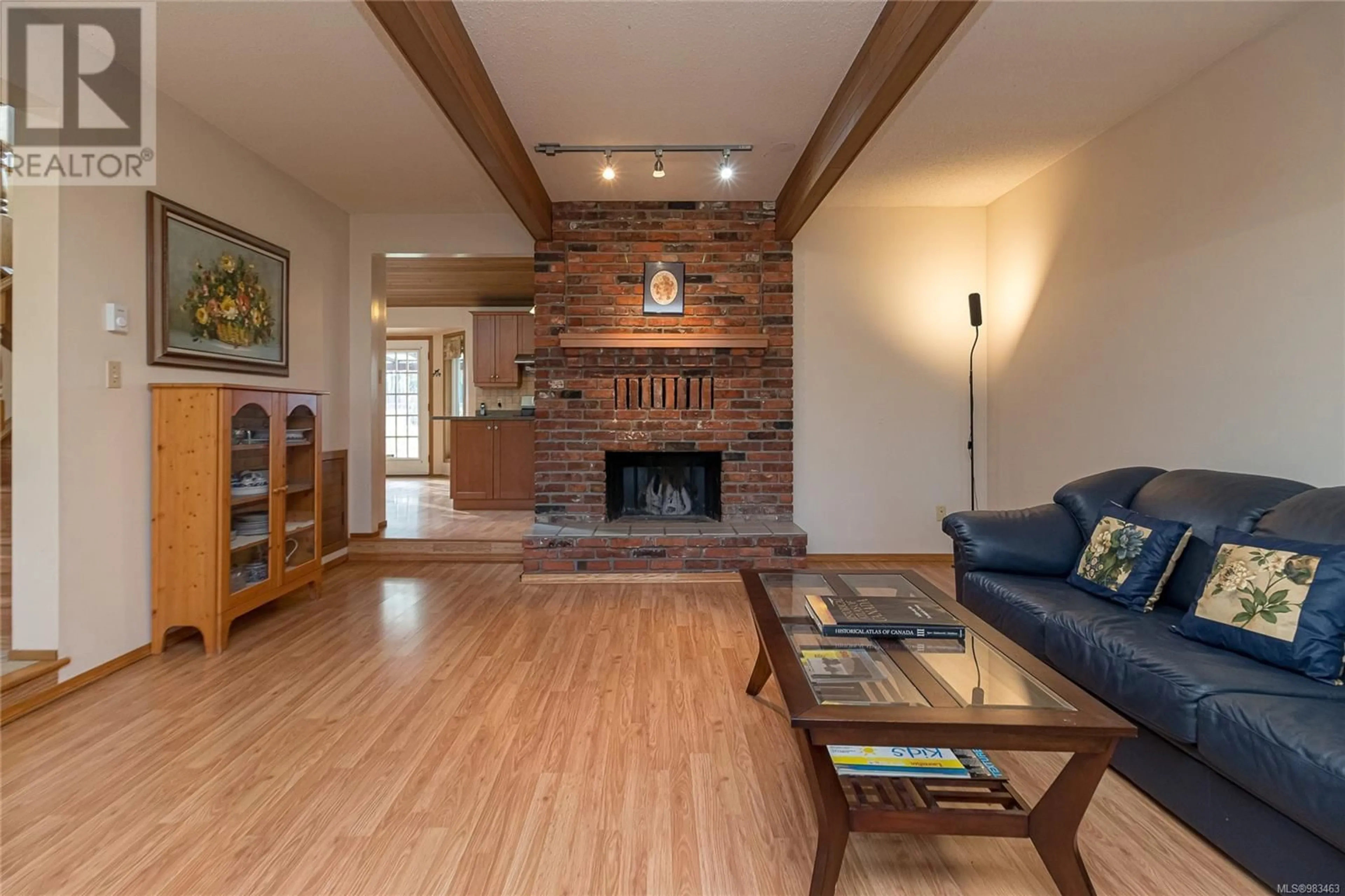 Living room with furniture, wood/laminate floor for 4475 Greentree Terr, Saanich British Columbia V8N3S9