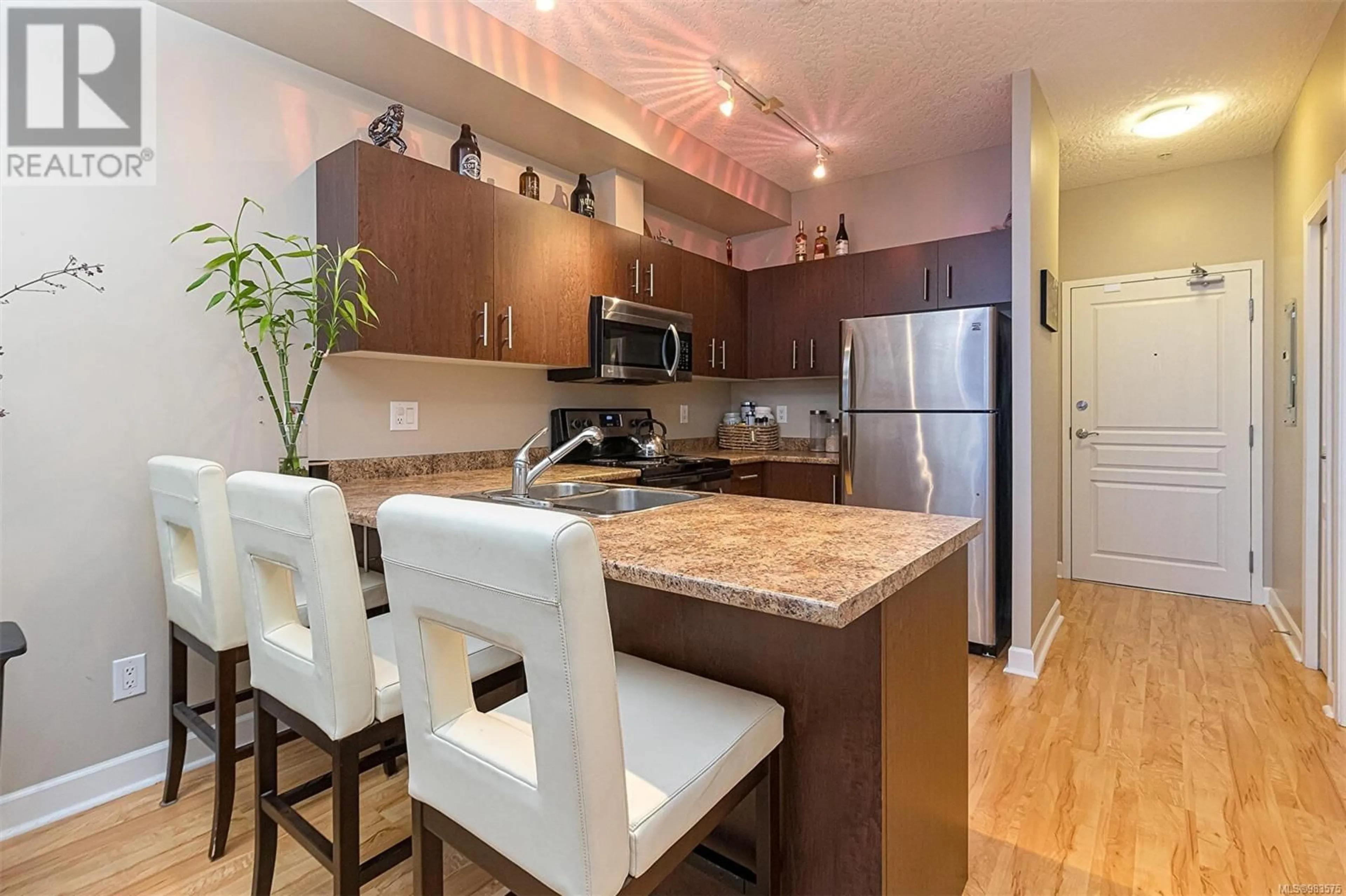 Open concept kitchen, wood/laminate floor for 207 825 Goldstream Ave, Langford British Columbia V9B0C3