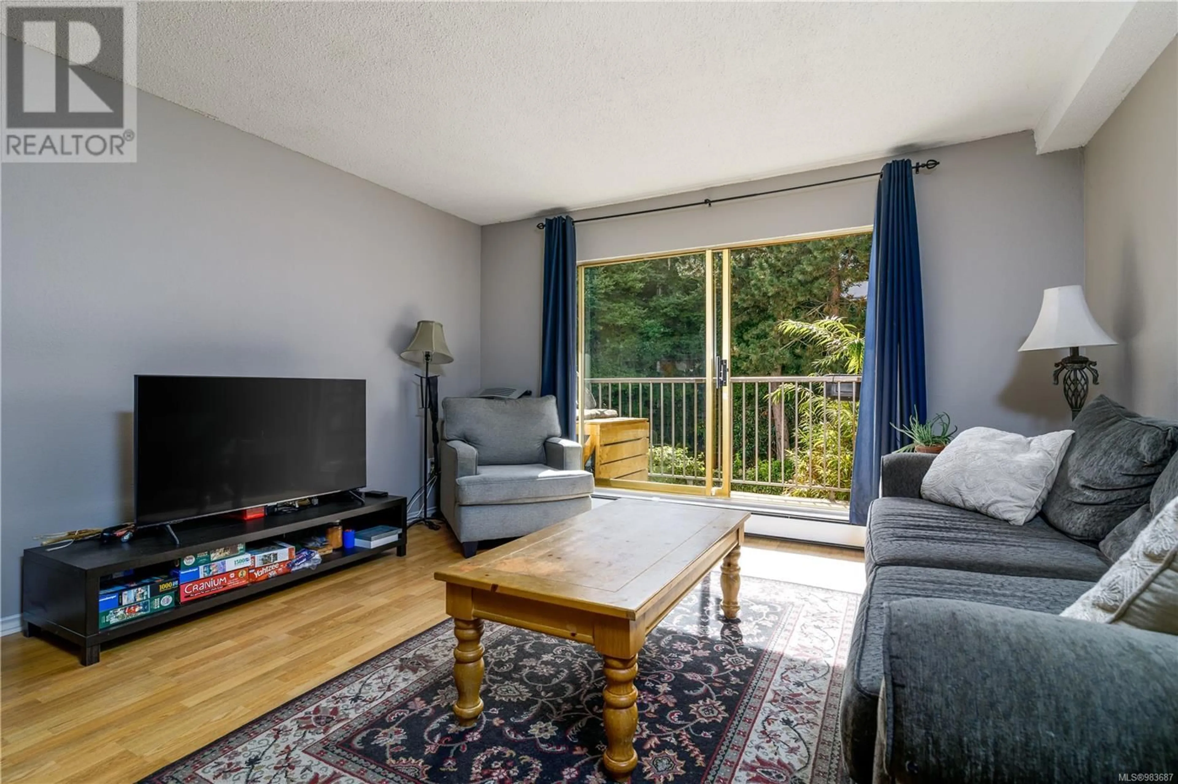 Living room with furniture, wood/laminate floor for 119 3225 Eldon Pl, Saanich British Columbia V8Z6A7