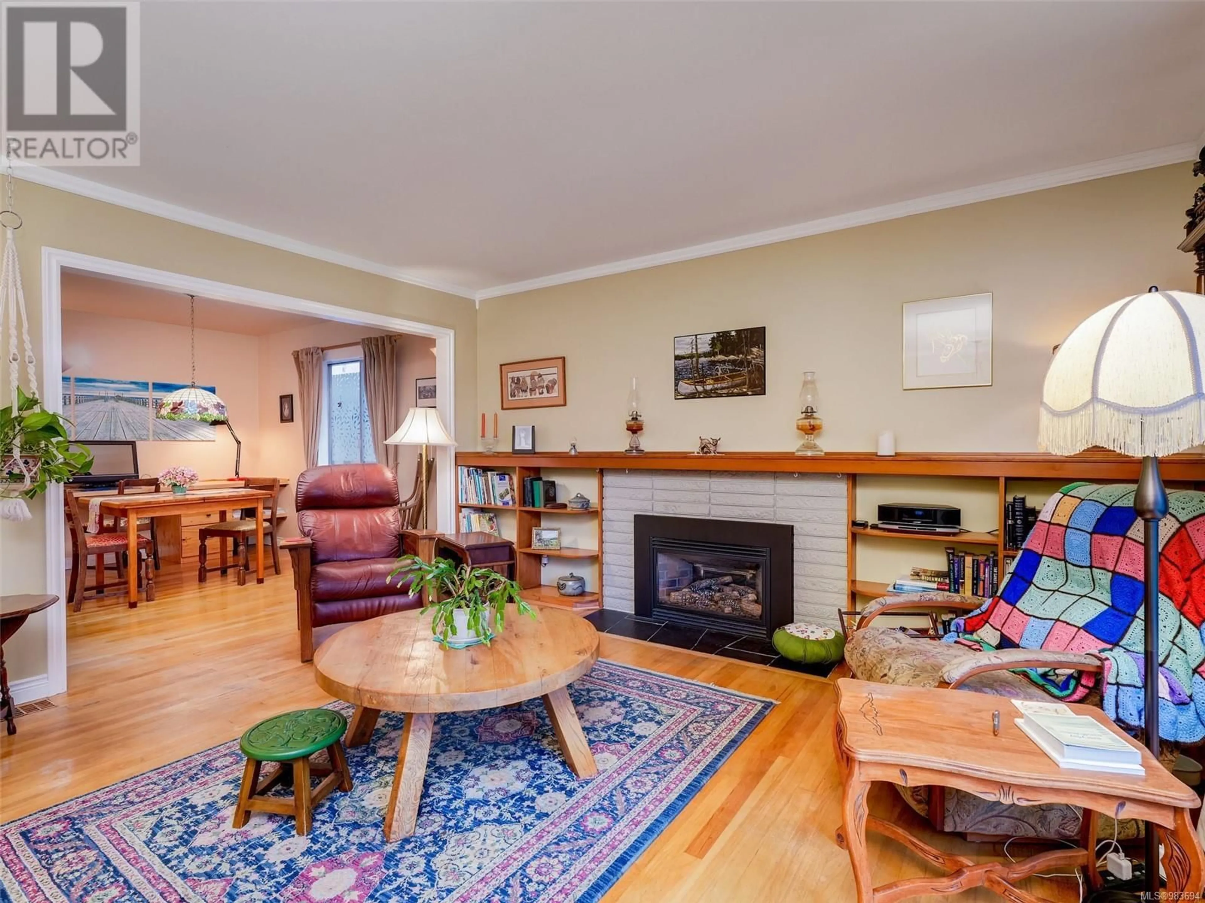 Living room with furniture, wood/laminate floor for 1610 Blair Ave, Saanich British Columbia V8N1M4