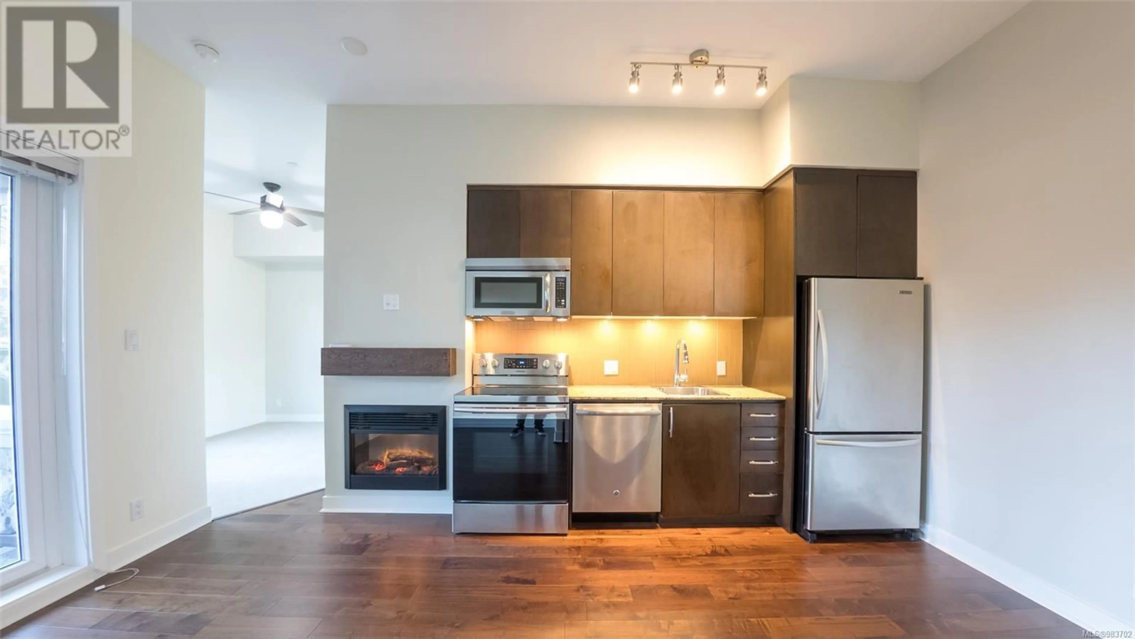 Open concept kitchen, wood/laminate floor for 117 1395 Bear Mountain Pkwy, Langford British Columbia V9B0E1