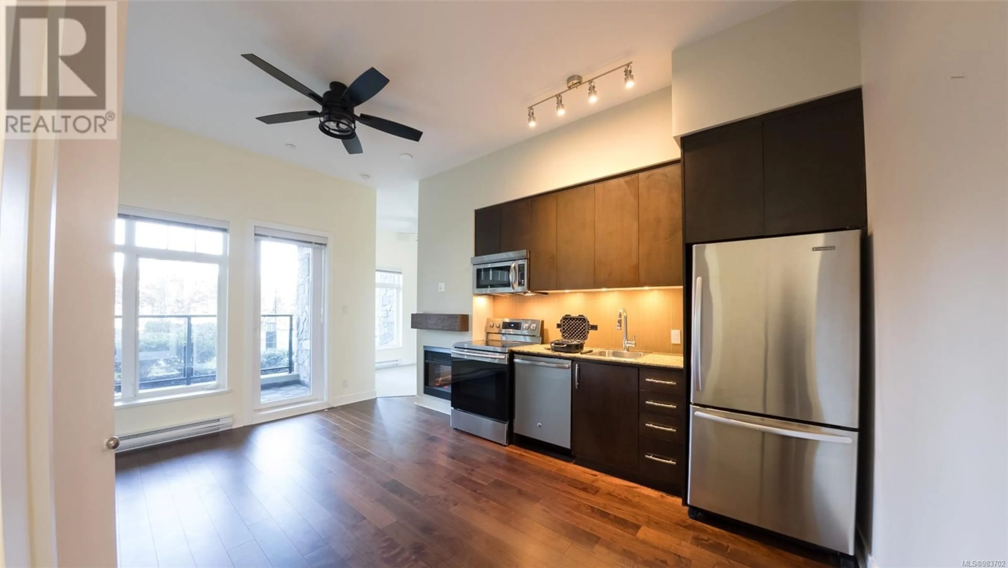 Open concept kitchen, wood/laminate floor for 117 1395 Bear Mountain Pkwy, Langford British Columbia V9B0E1