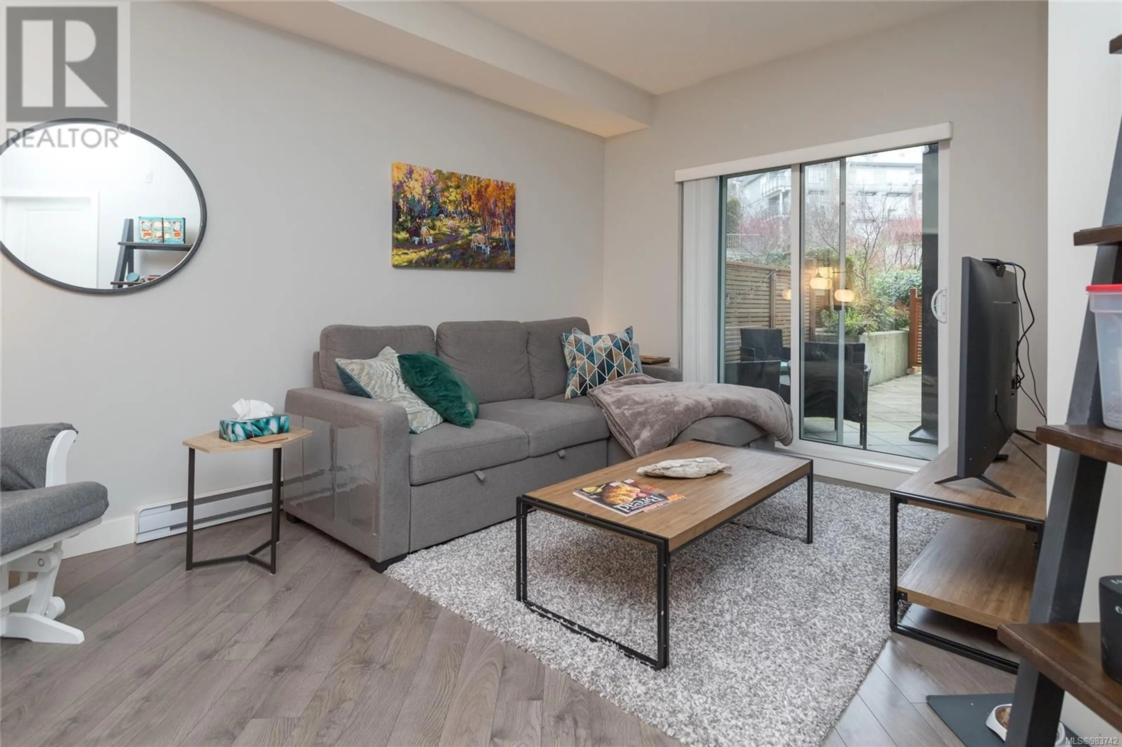 Living room with furniture, wood/laminate floor for 103 1000 Inverness Rd, Saanich British Columbia V8X2S1