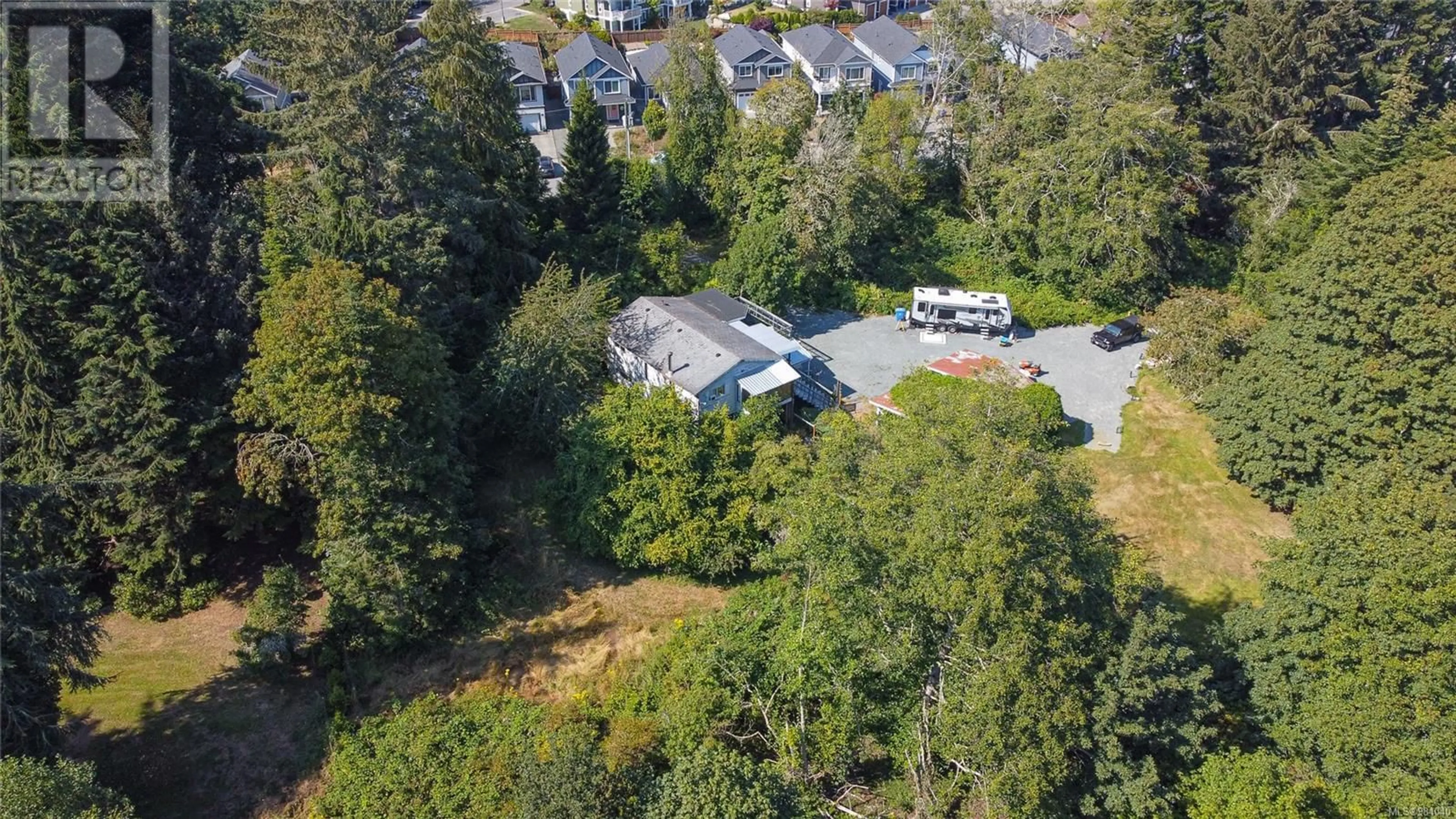 A pic from outside/outdoor area/front of a property/back of a property/a pic from drone, forest/trees view for 7015 Wright Rd, Sooke British Columbia V9Z1M5