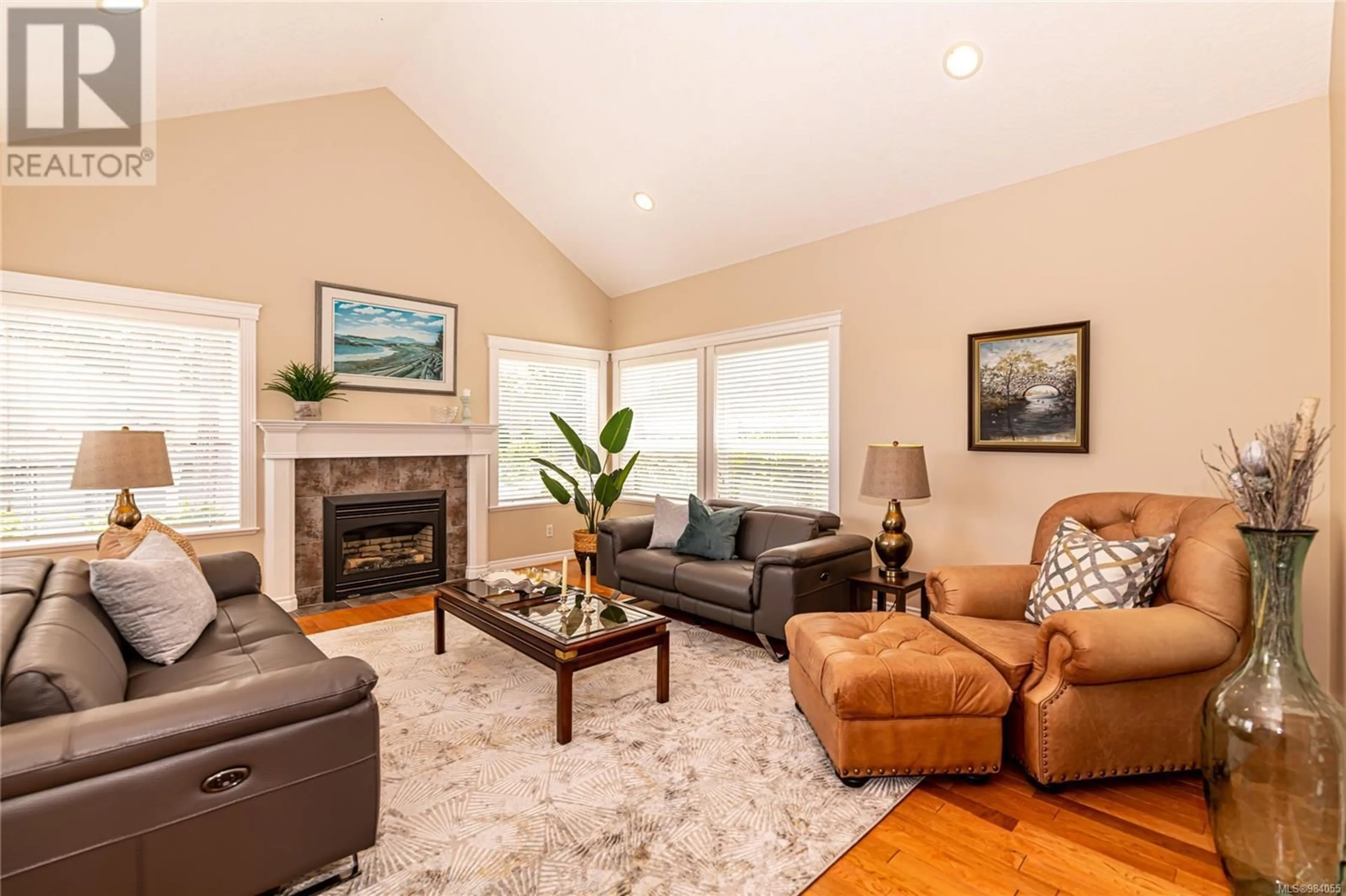 Living room with furniture, wood/laminate floor for 5300 Mynabird Lane, Saanich British Columbia V8Y3H6