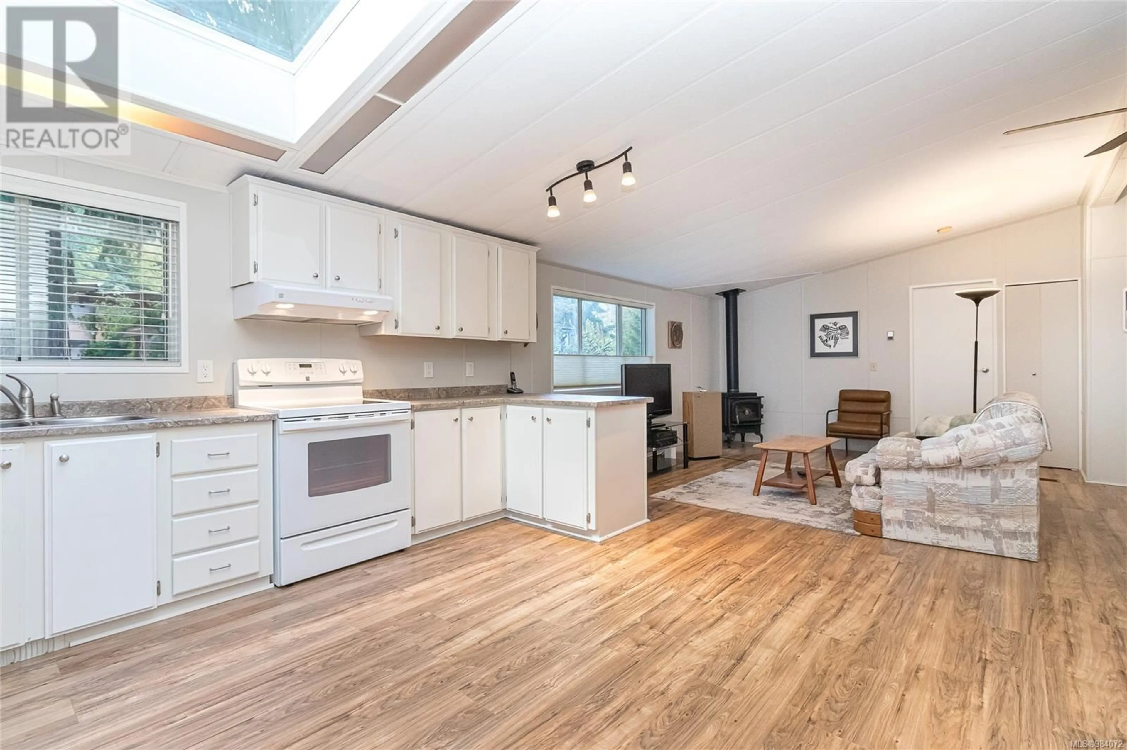 Open concept kitchen, wood/laminate floor for 3 6350 Island Hwy W, Qualicum Beach British Columbia V9K2E5