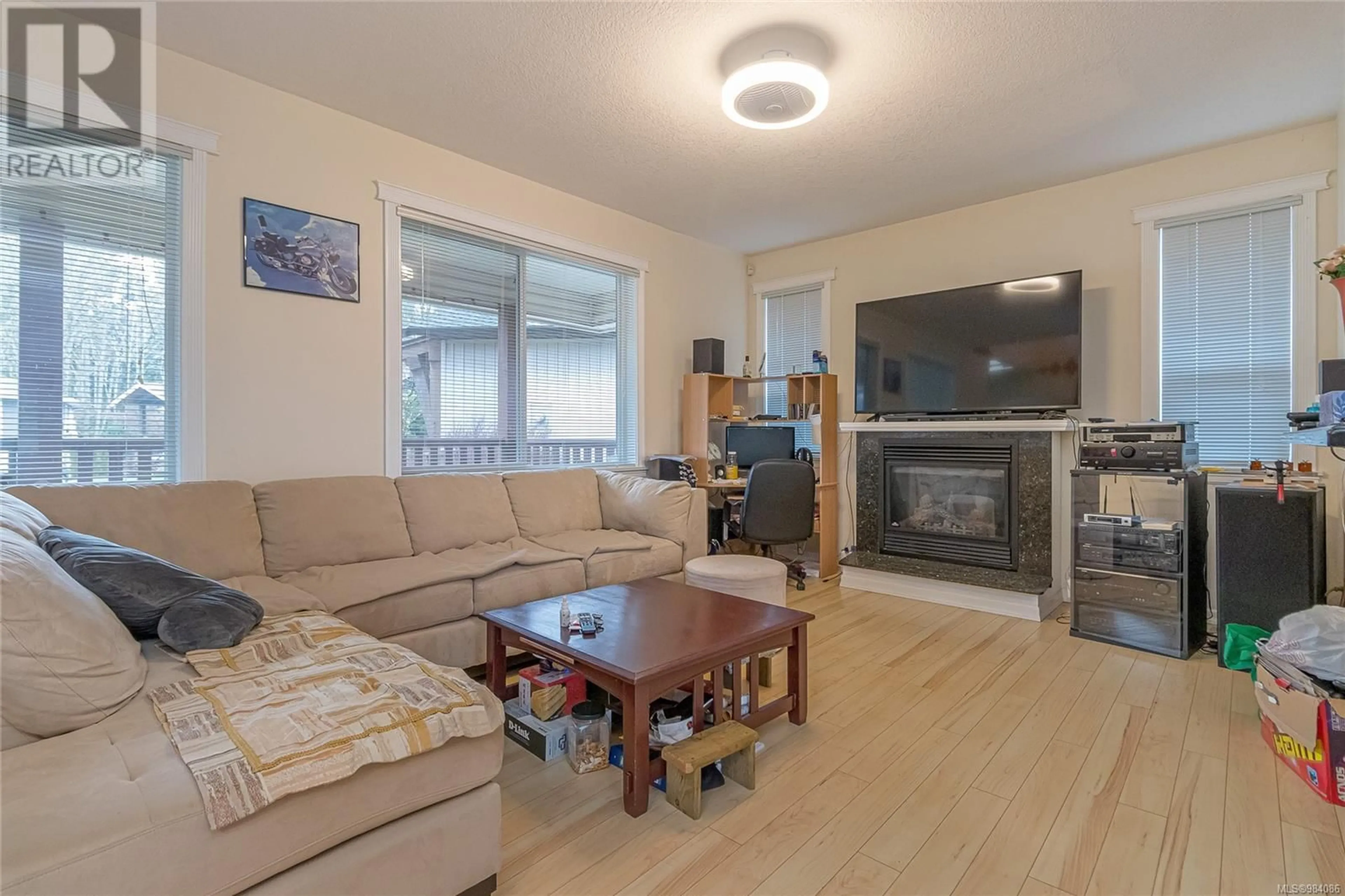 Living room with furniture, wood/laminate floor for 6183 Dennie Lane, Nanaimo British Columbia V9T0A5