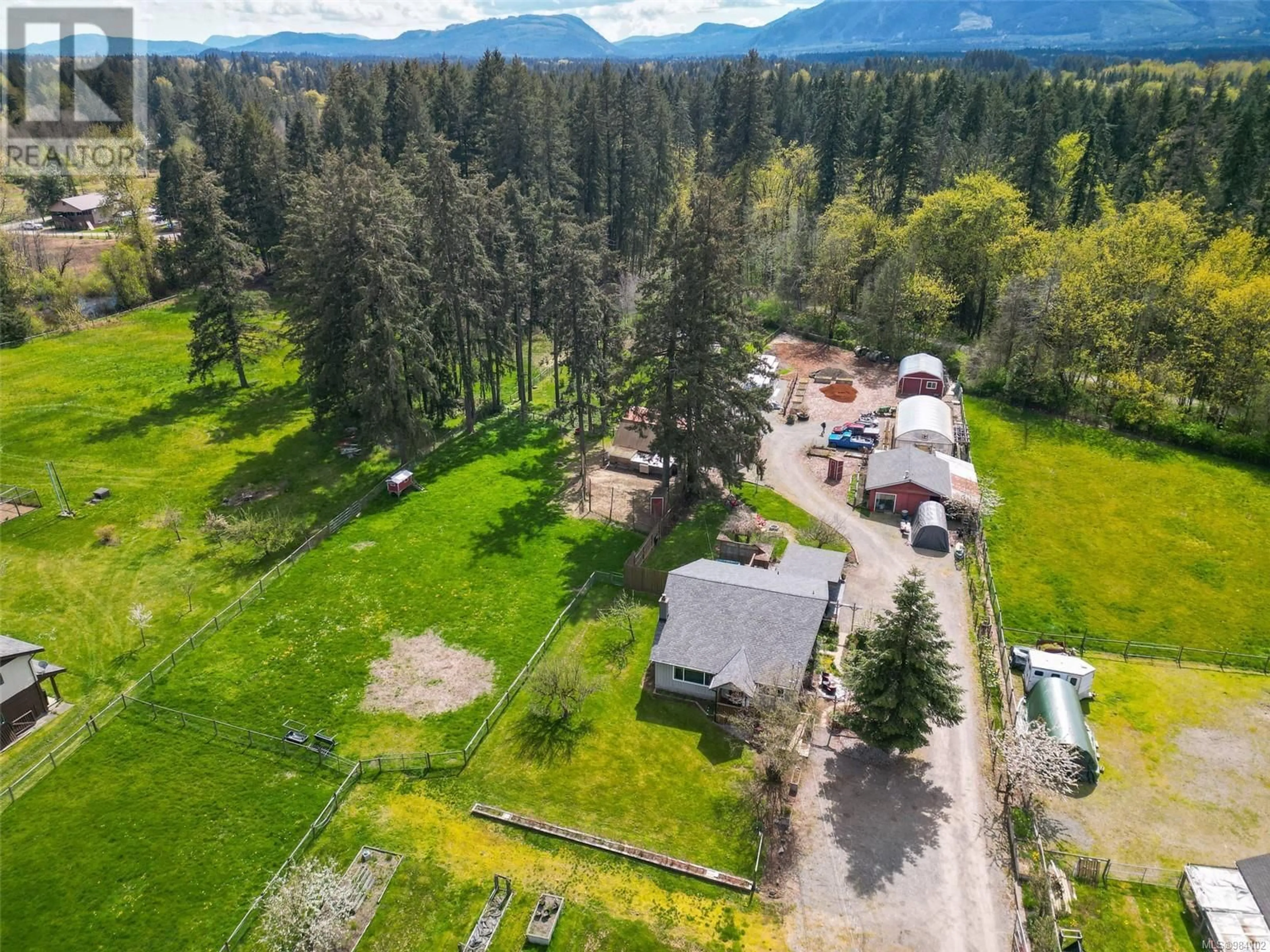 A pic from outside/outdoor area/front of a property/back of a property/a pic from drone, mountain view for 3574 Cowichan Lake Rd, Duncan British Columbia V9L6K5